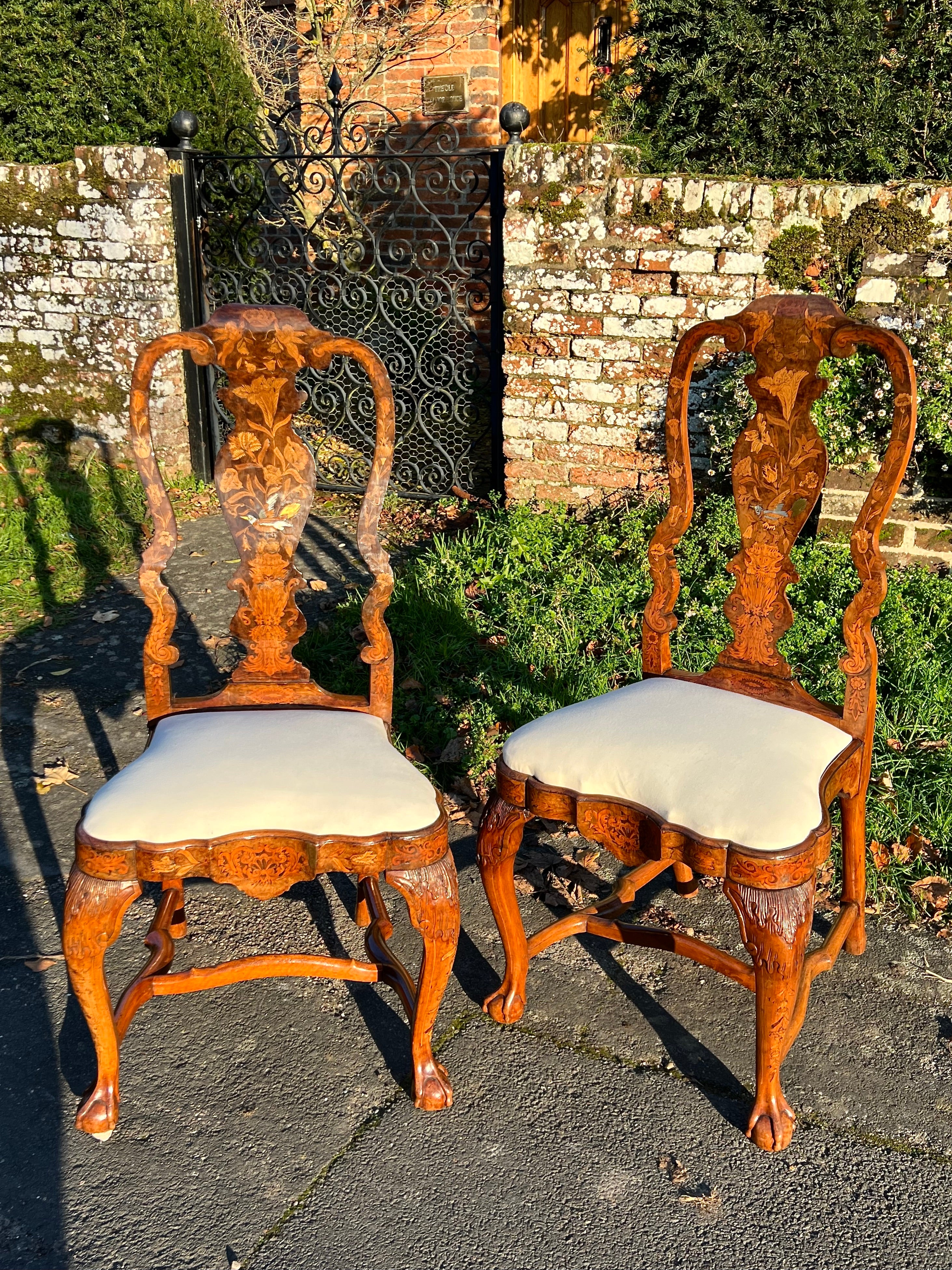 Eight fine closely-matched 18th-century Rococo-inspired floral marquetry chairs in walnut. Circa 1760.
Carved on the knees and with serpentine seat rails, surfaces profusely and beautifully inlaid with flowers and birds.

All of great colour and