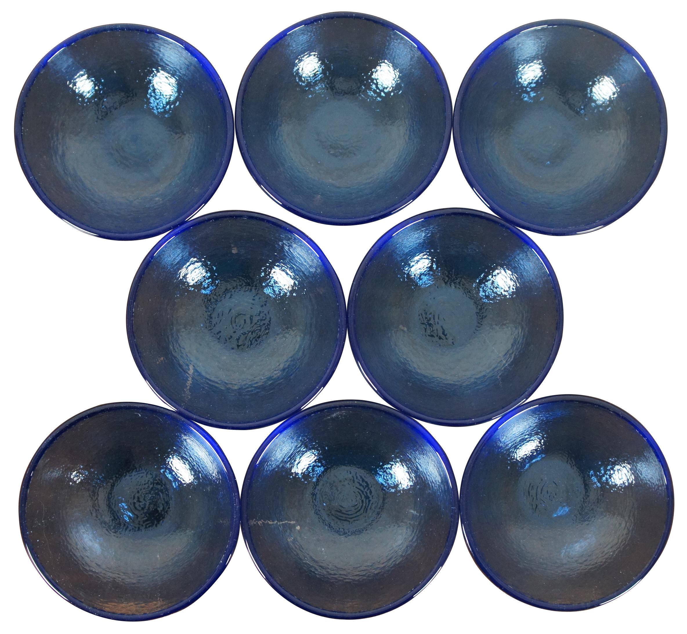 Set of eight cobalt blue pebbled glass bowls by Fire & light recycled art glass. Measure: 6”.
 