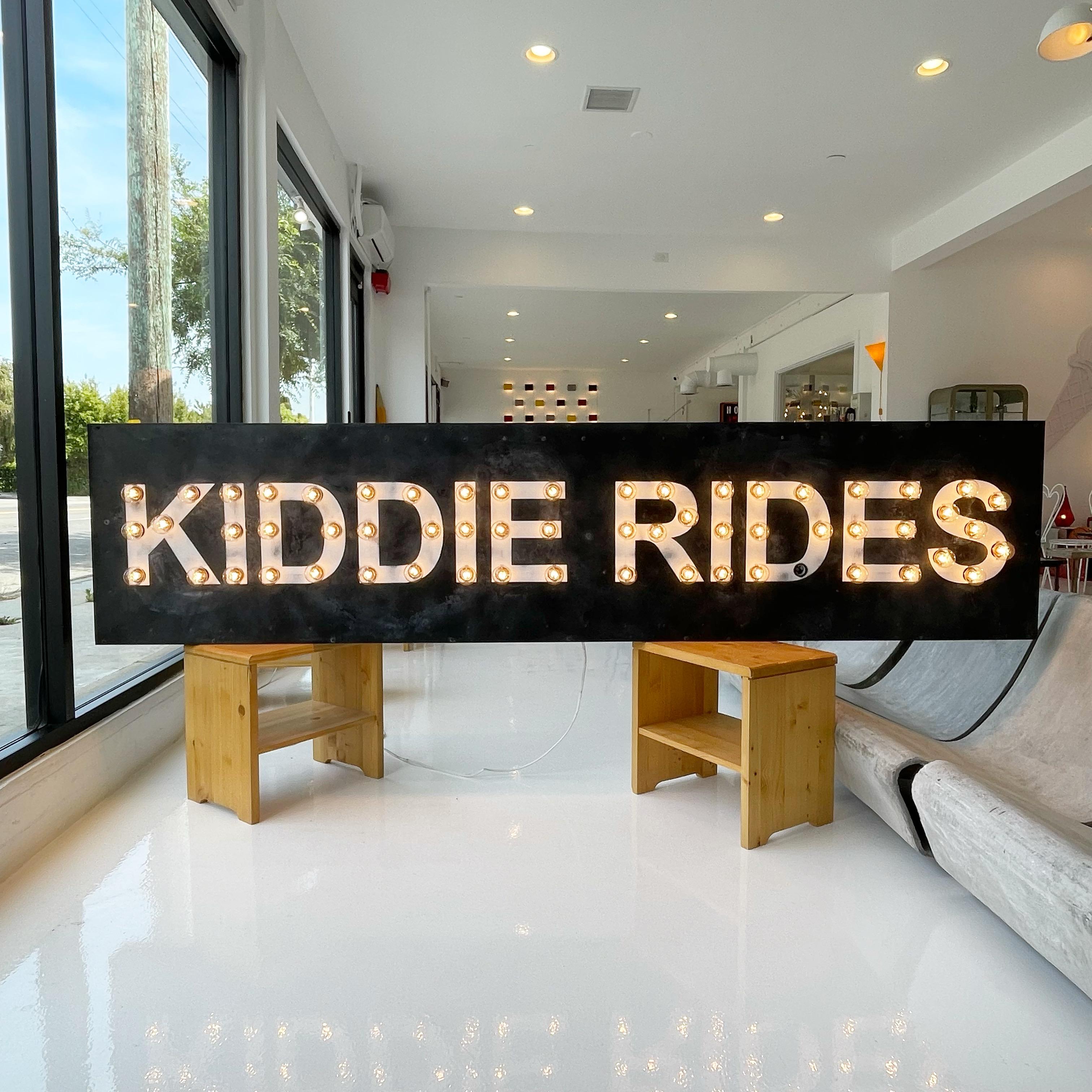 8 foot metal sign from an old carnival. Metal sign with wood backing. Hand painted wording - KIDDIE RIDES. Marquee lighting on each letter. Perfect working condition. Newly rewired. Great condition. Fun piece of wall art.