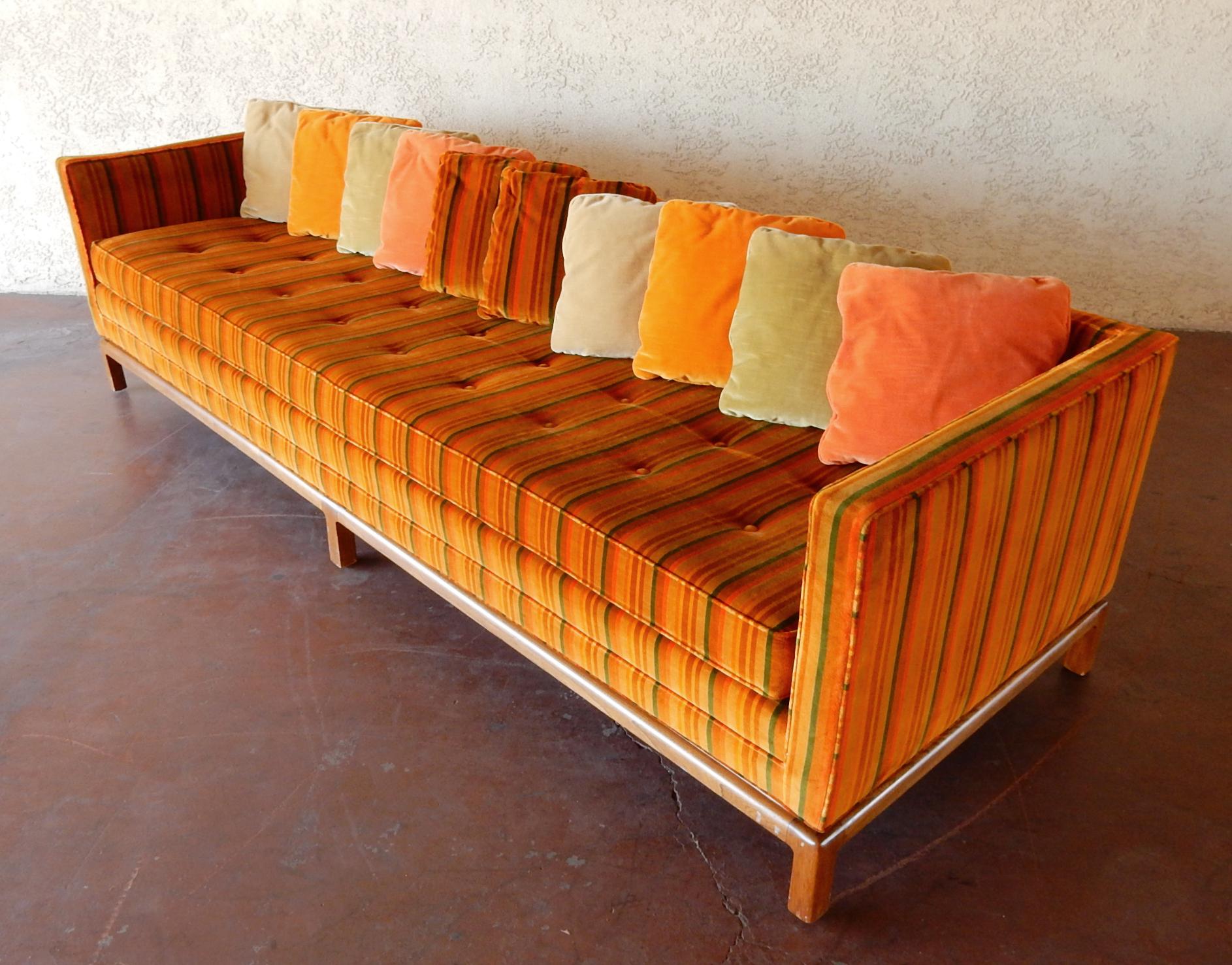 Electrifying 8 foot midcentury sofa by Flair Inc, a division of Bernhardt Furniture of the 1960s and 1970s.
Vivid muted cinnamon red, golden wheat and orange hue Jack Lenor Larsen style velvet upholstery.
A single seat cushion with 10 original