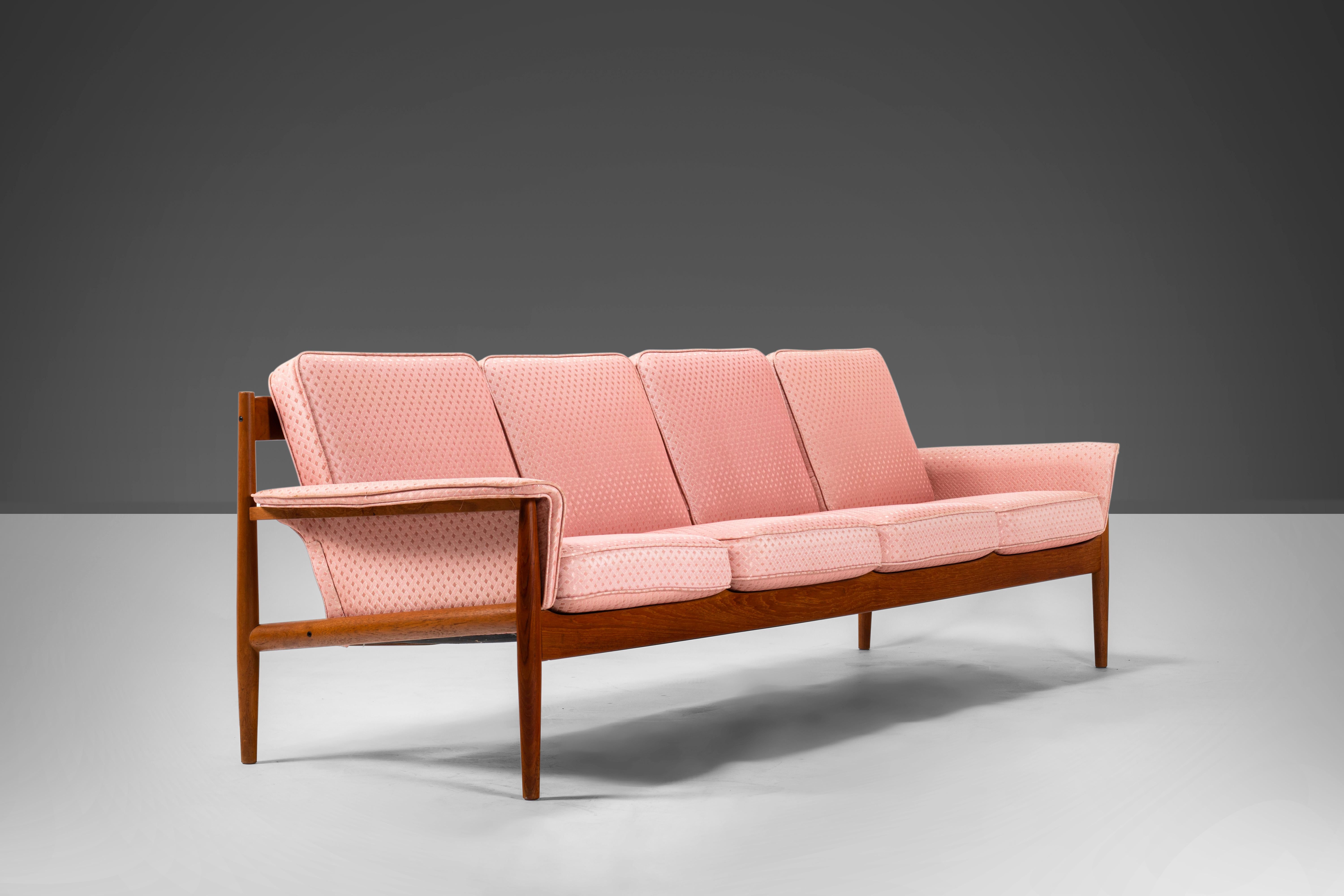 Rare and exceptional is this sculptural sofa by Grete Jalk for France & Son. This four-seat sofa features contoured slats that create a spectacular line from the back and side angles. The flared armrests and original sprung cushions are upholstered