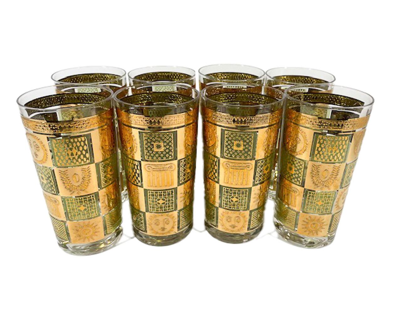 Set of eight vintage highball glasses designed by Georges Briard and having a 22 karat gold check pattern over translucent green enamel. Each square contains a classical motif including suns with faces, column capitals and lyres together with other