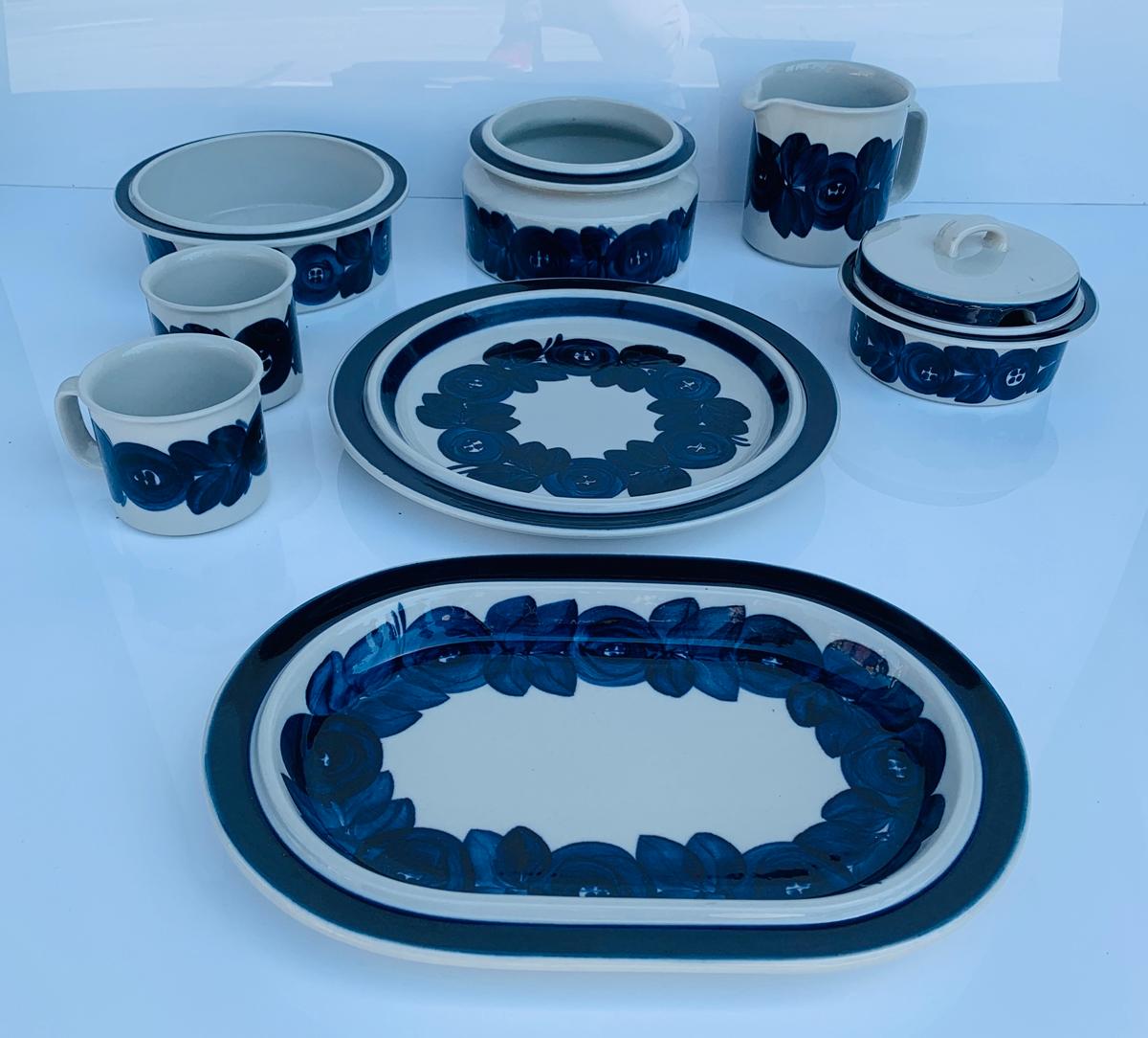 Set of 8 Anemone serving dishes hand-made and hand-painted by Ulla Procope for Arabia of Finland.

The set consists of one large round platter, one large oval platter, 2 coffee mugs, one beer pitcher, 2 serving bowls and a soup tureen with a