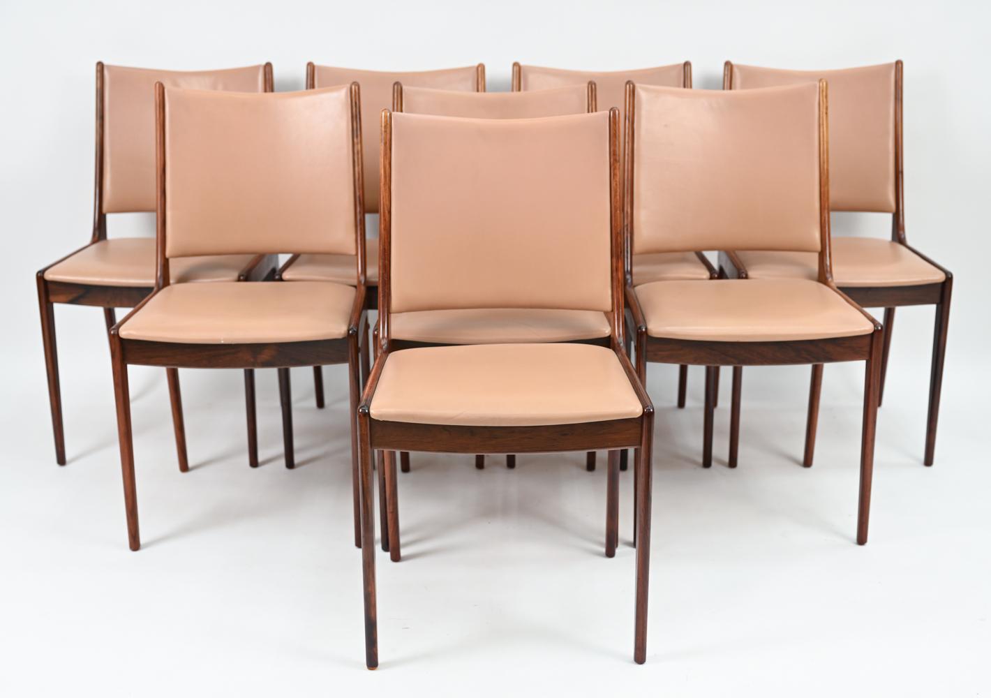 A gorgeous set of eight Danish mid-century dining side chairs, designed by Johannes Andersen and produced by Uldum Mobelfabrik. These Model 7171 chairs feature attractive, refined frames in warm hued rosewood with gently sloping sides. Subtly curved