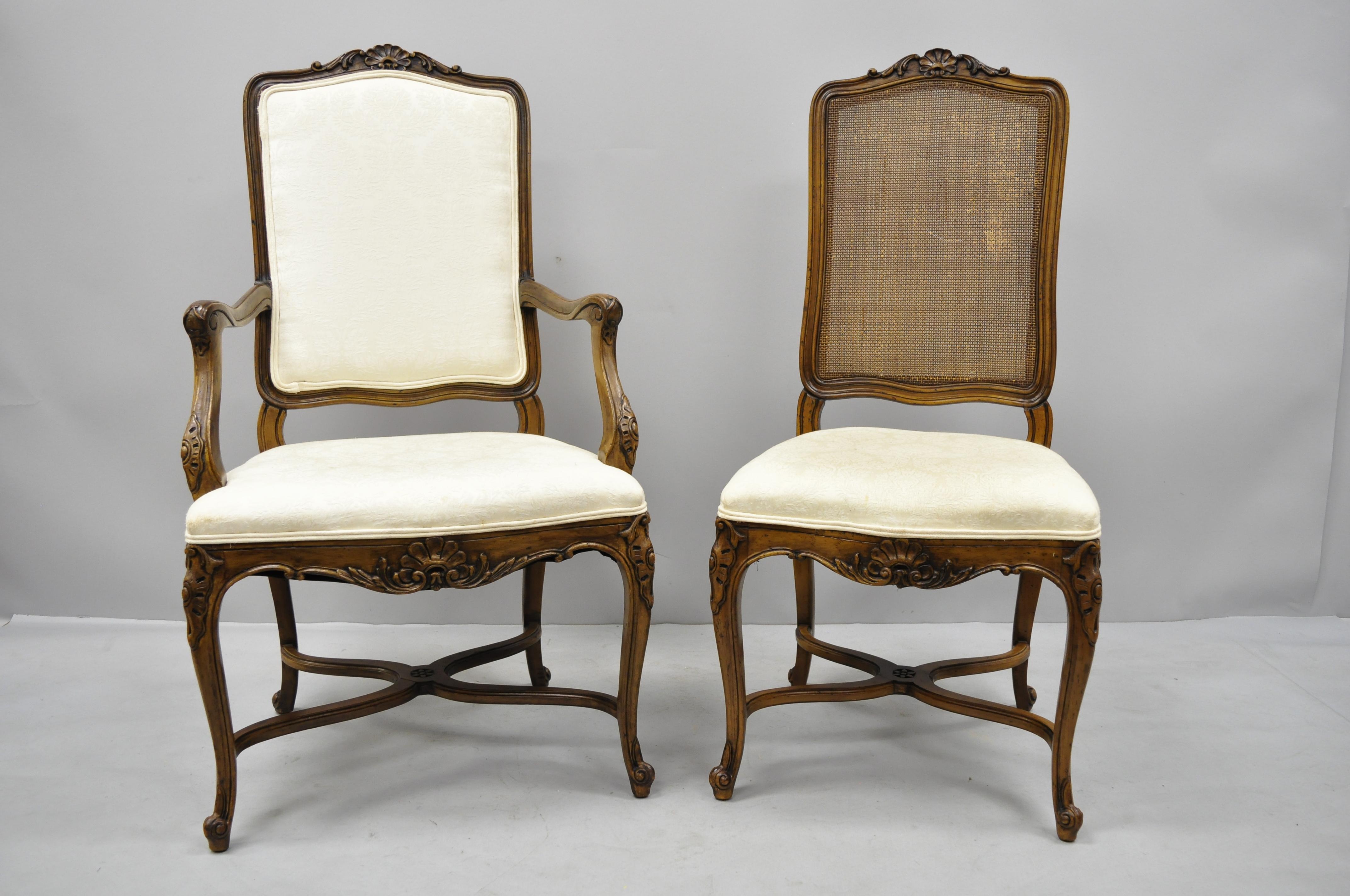 8 John Widdicomb carved walnut cane back French Country Louis XV style dining chairs. Listing includes 2 armchairs, 6 side chairs, shell carved top rail and lower rail, stretcher supports, cane backs, circa mid-20th century. Measurements: Armchairs