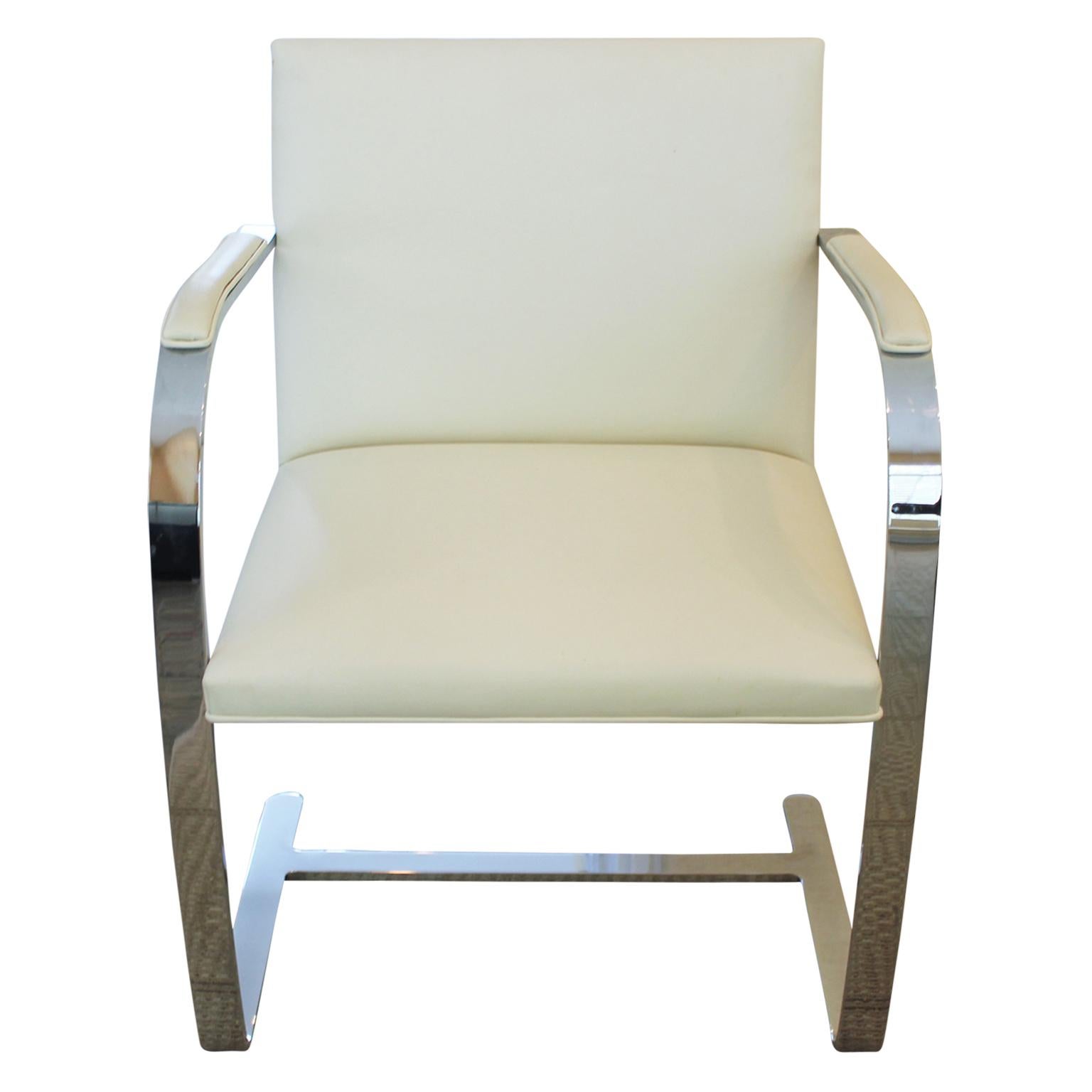 Chrome and white leather modern Knoll chairs with arms and leather accents on the arms. The leather has wear and they need to be reupholstered.