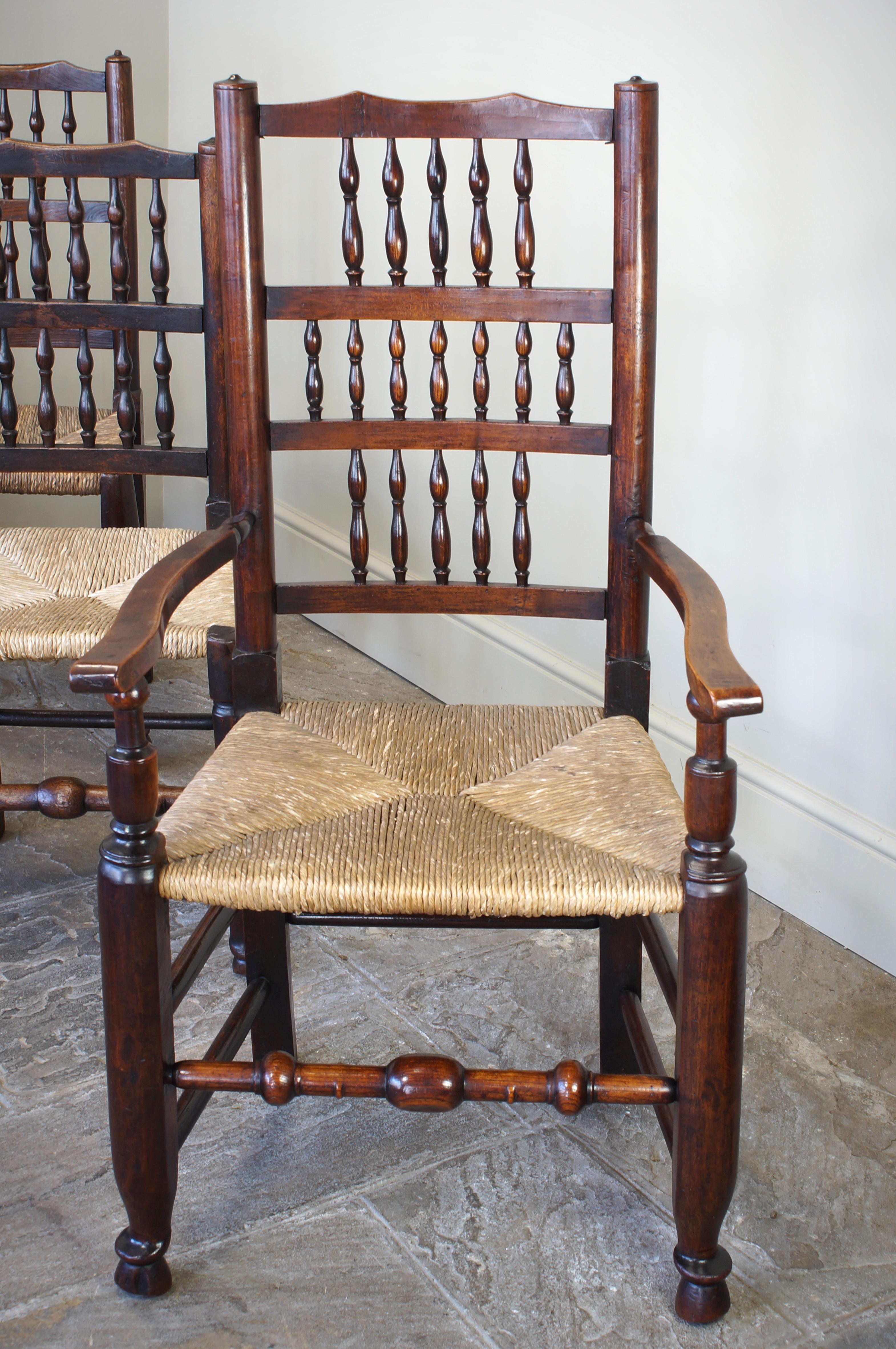 This ash and elm mixed Set of 8 Lancashire spindle back chairs are
made in the desirable Lancashire spindle back design.
The mixed set consists of a pair of armchairs and 6 side chairs.
All have their original rush seats, that are in good