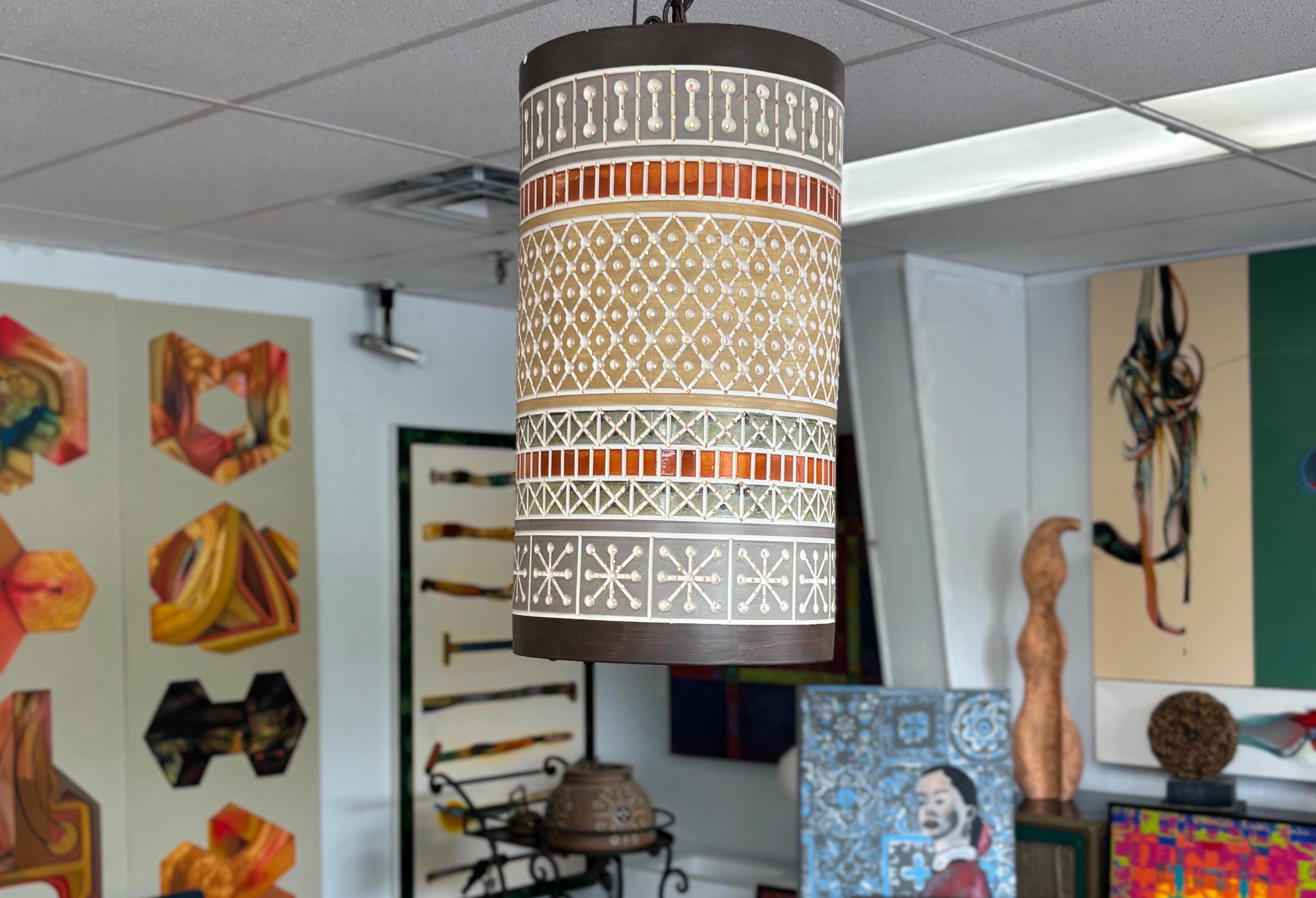 Eight ceramic Beaumont Mood pendants, these large vintage perforated ceramic ceiling fixtures are in overall great condition, and create a beautiful warm glow. Beaumont Mood worked for the renowned Texas architect O'Neill Ford, and created many