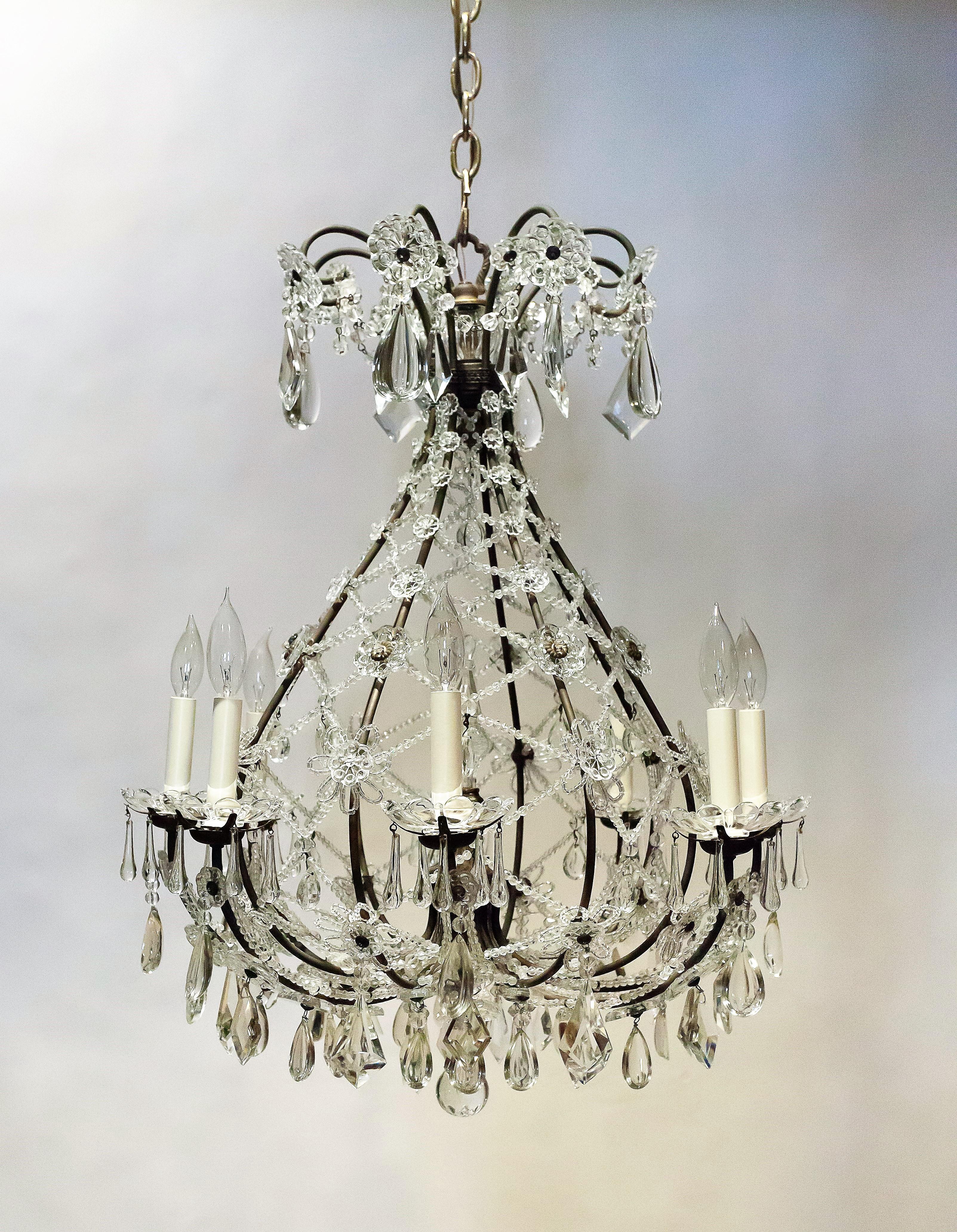 This whimsical inverted balloon fixture is an excellent example of a Neoclassical cage chandelier. While the original of the design was French, the intricate crystal bead work as well as the other ornament is the high quality work of Italian