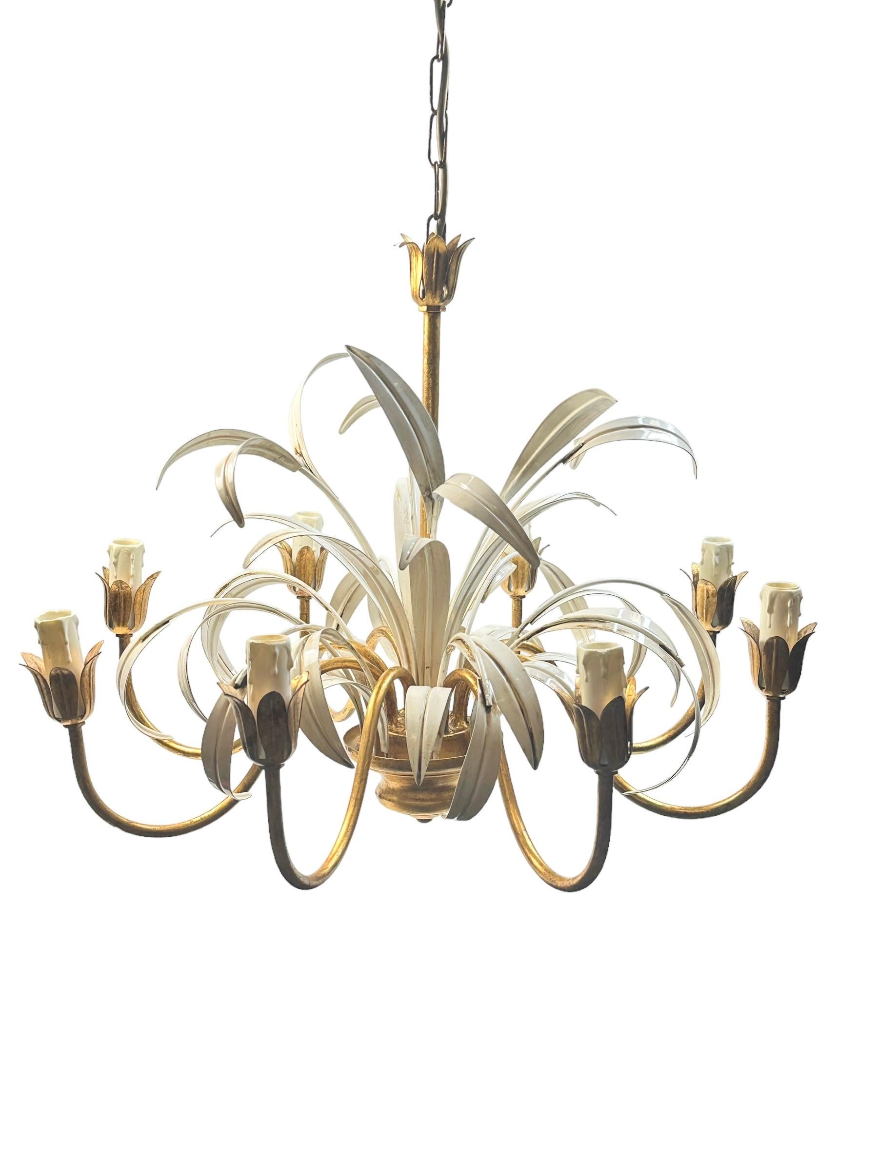 Gilt Italian Floral reed leaf eight-light chandelier Coco Chanel Hollywood Regency style, inspired by Coco Chanel. This tole pendant lamp has a warm antique gold finish which is enhanced by daylight or artificial light reflecting off its surface.