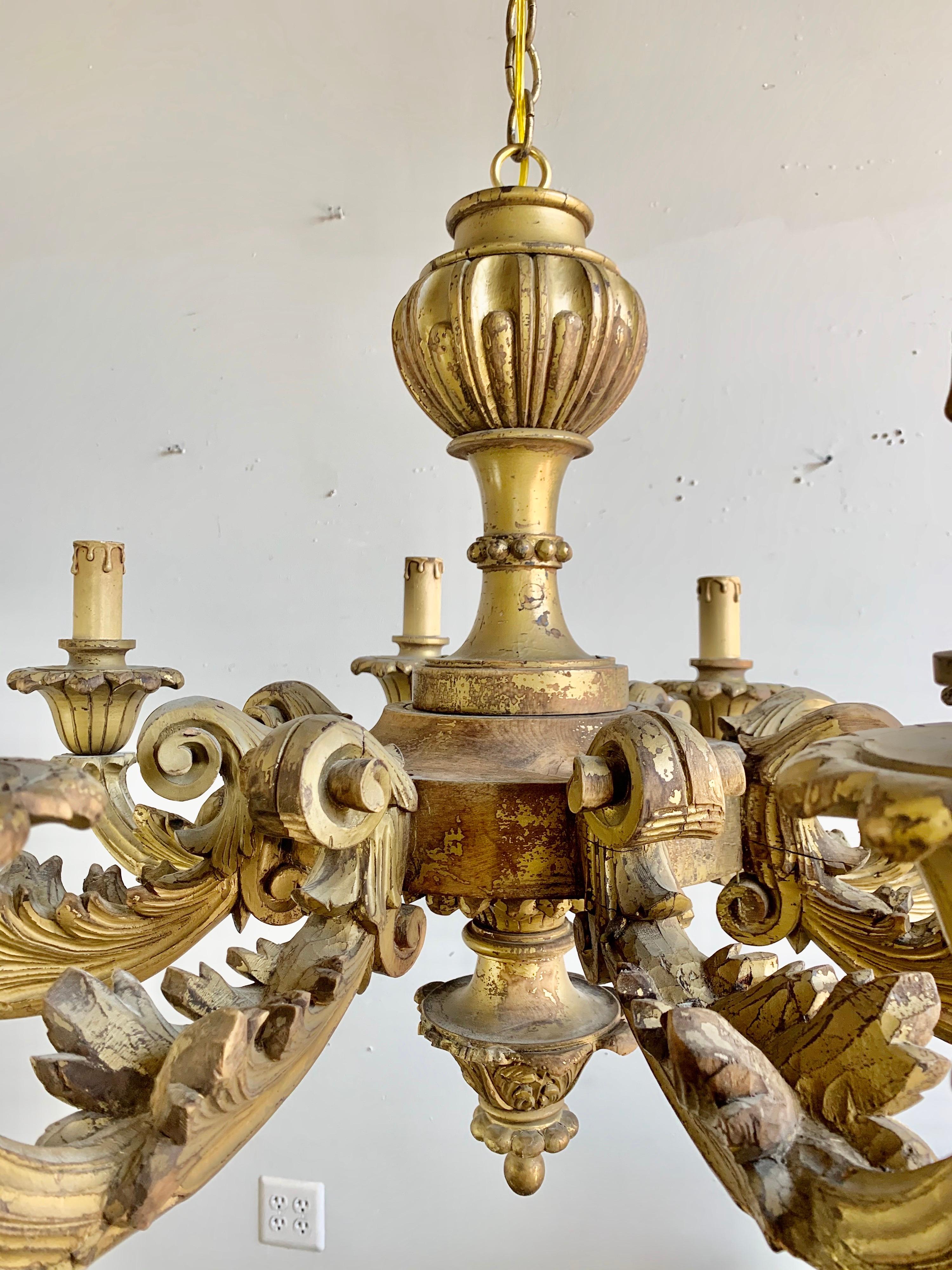Italian 8-light 22-karat gold leaf carved wood chandelier wired and includes chain and canopy. Ready to install.