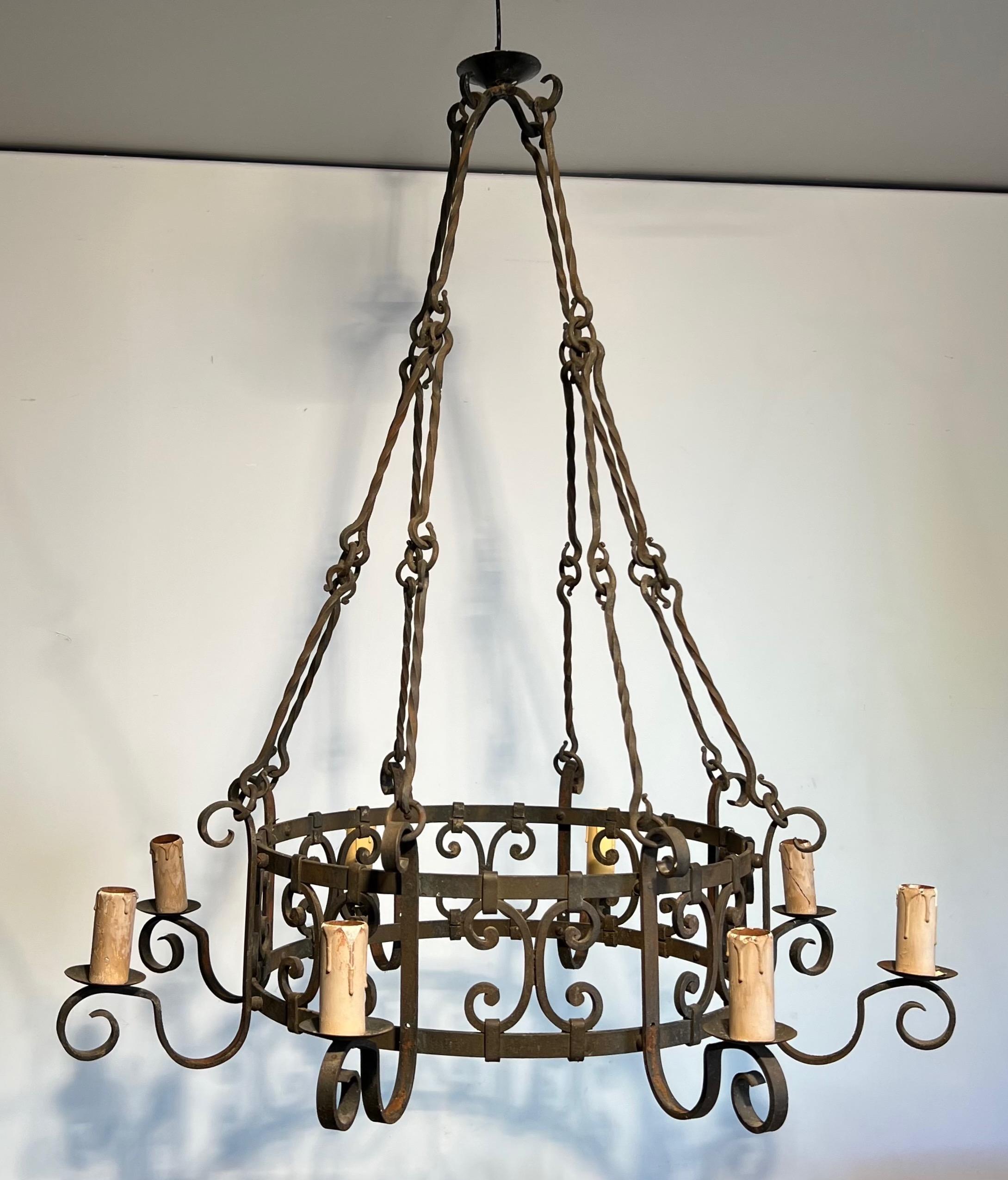 This nice and large wrought iron chandelier is round with nice decorations and beautiful chains. This is a French work in the Gothic style. Circa 1950

