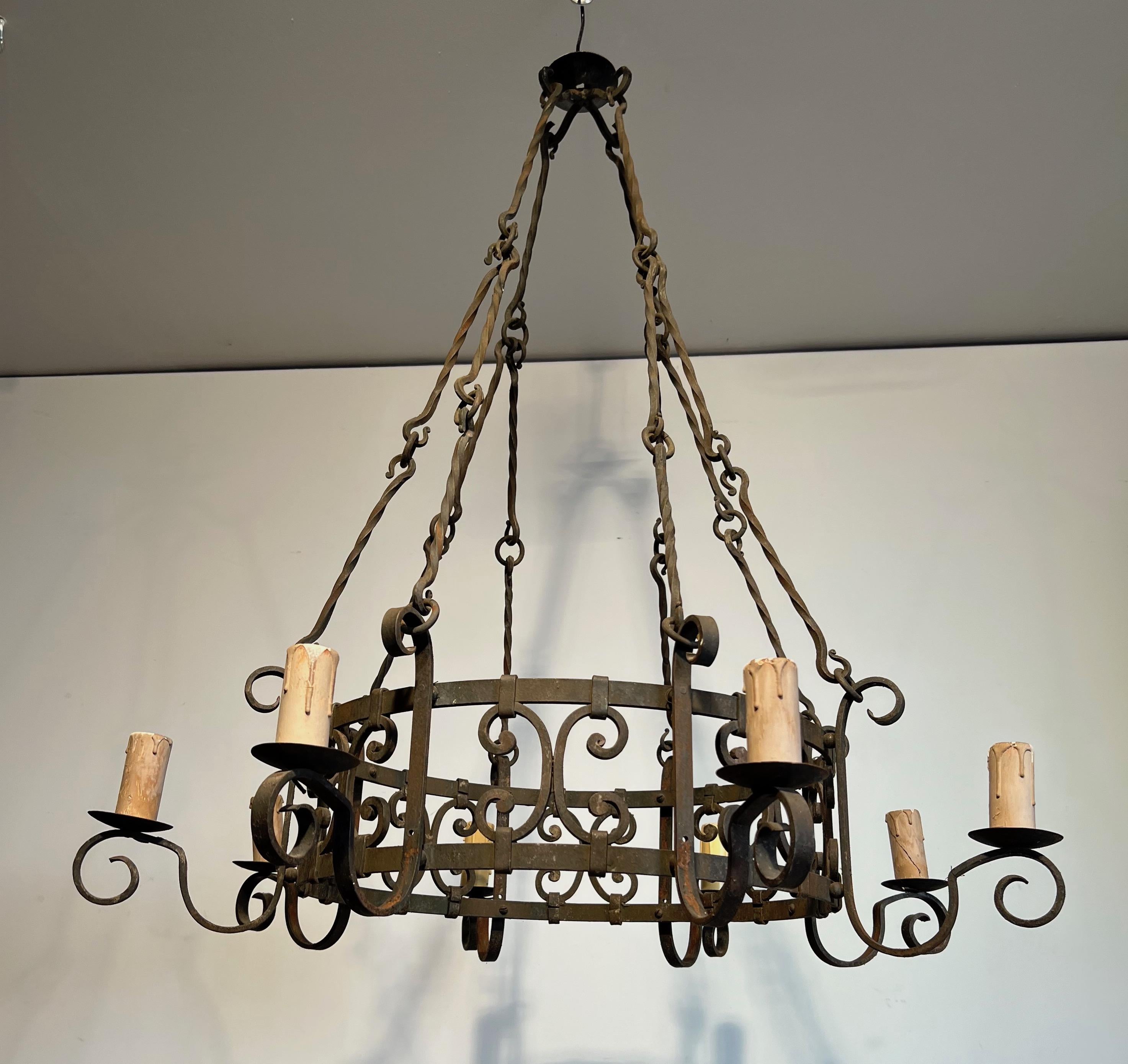 Gilt 8 lights wrought iron chandelier. French work in the Gothic style. Circa 1950