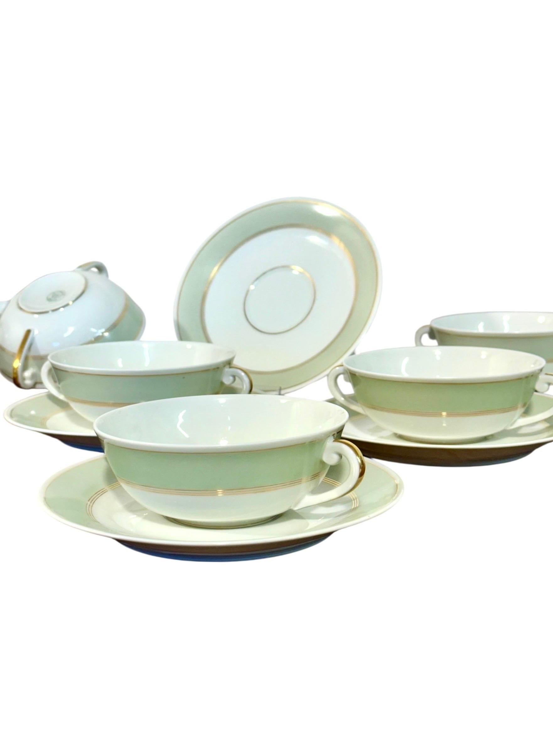 This elegant set of French porcelain bouillon cups with matching saucers was crafted by A. Vignaud, Limoges, renowned for their fine quality porcelain during the late 19th and early 20th centuries. Dating from the early 20th century (circa