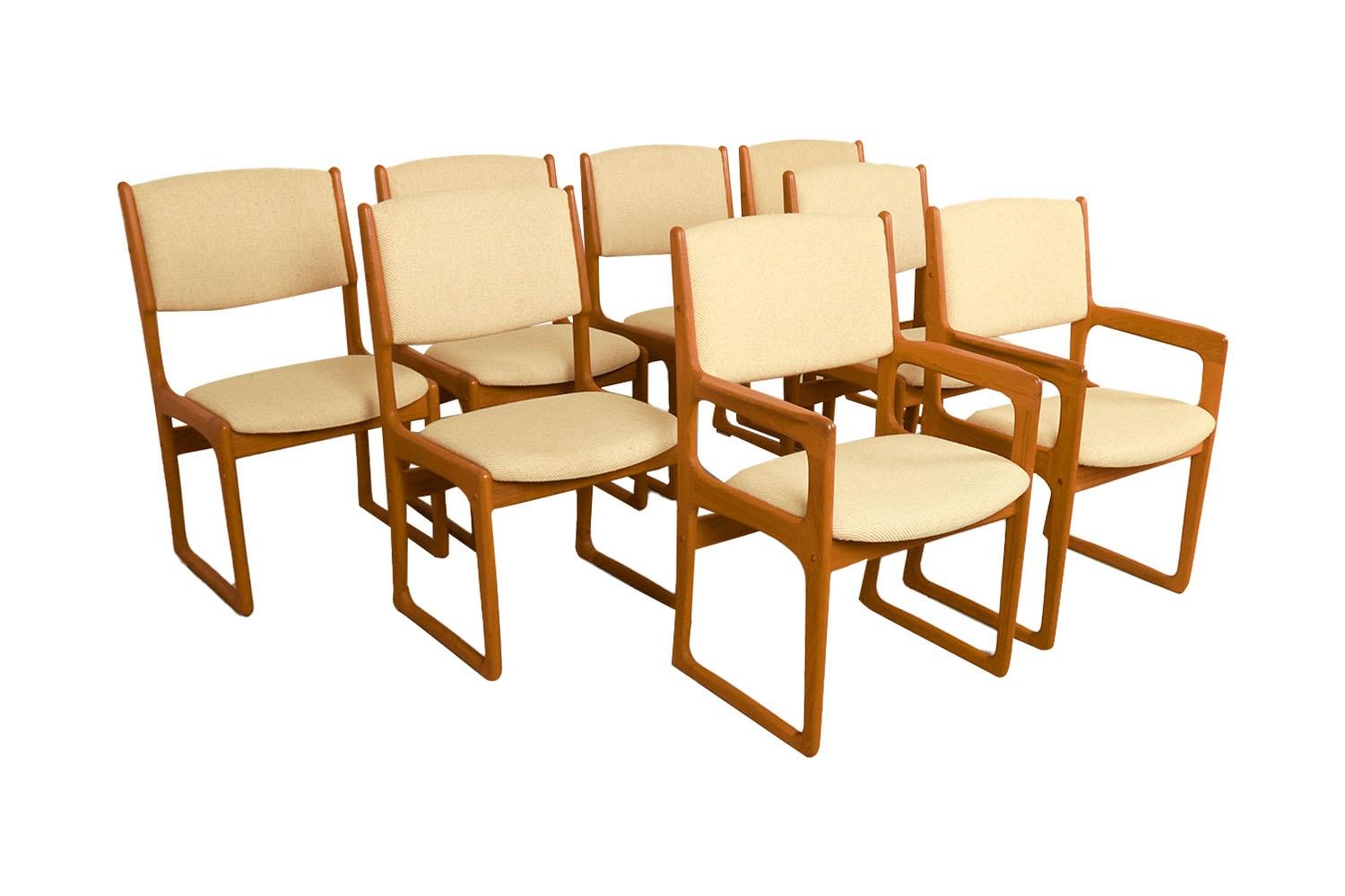 Set of eight beautifully sculpted Danish Modern teak-dining chairs designed by Benny Linden. Maker’s label under seat {Benny Linden Design}. Superbly crafted, sculpted, modern teak dining chairs with padded backrests and seats, this set includes two
