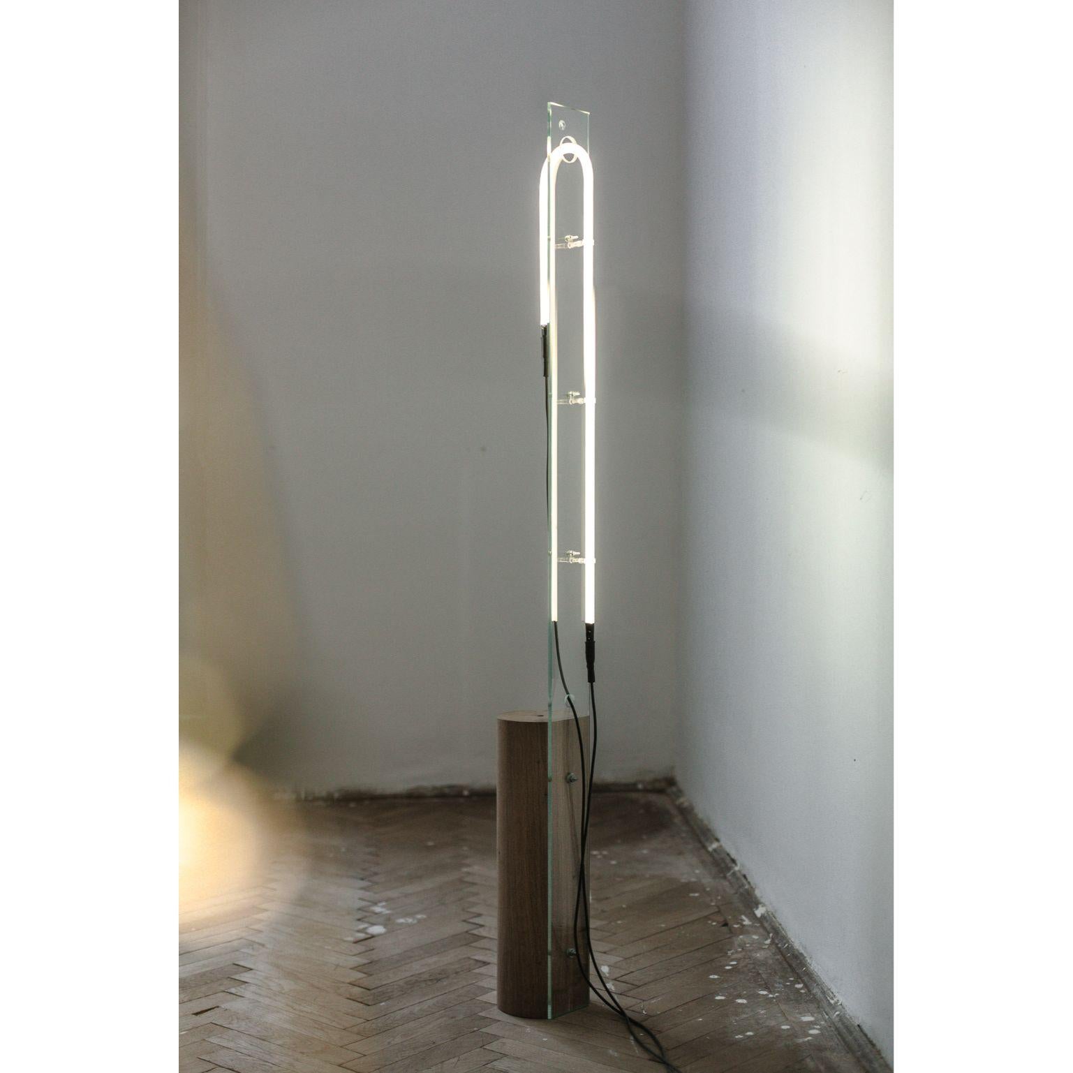 8 minutes straight by Radu Abraham.
Materials: Oak wood, glass, custom made light tube
Dimensions: 15 x 15 x 170 cm.

All our lamps can be wired according to each country. If sold to the USA it will be wired for the USA for instance.

The base