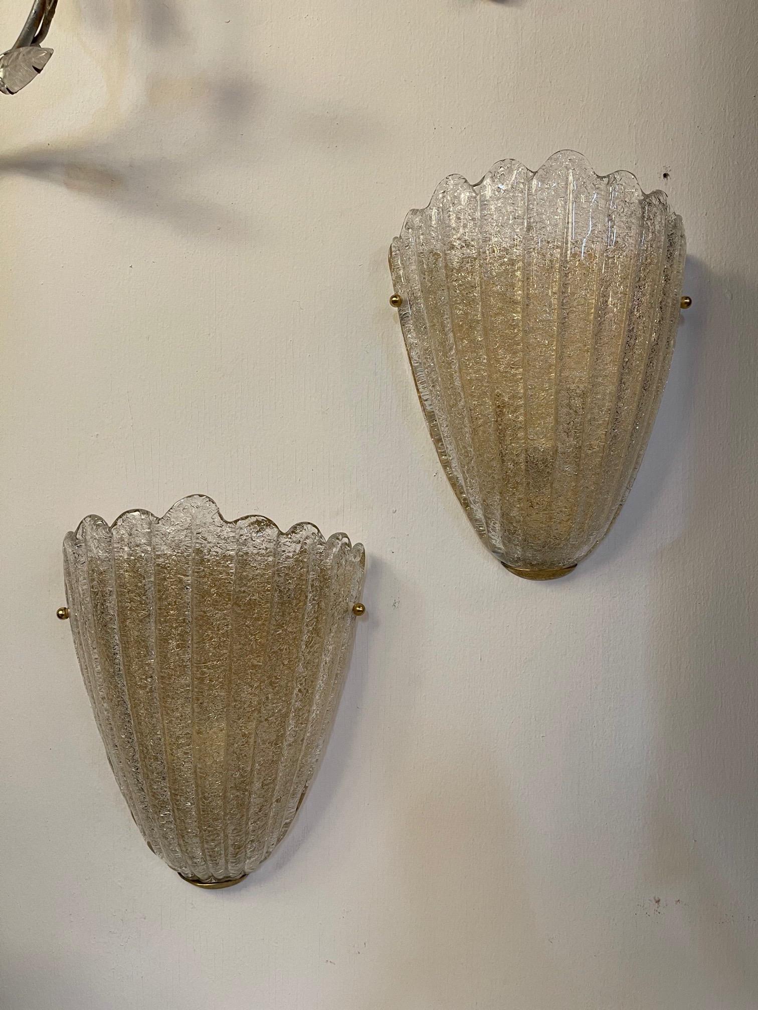 Decorative shell shaped Murano glass sconces. These have such a pretty shape with a lovely textural element. Great for a variety of decors!! Note: There 8 sconce. Price listed is for 1 pair.