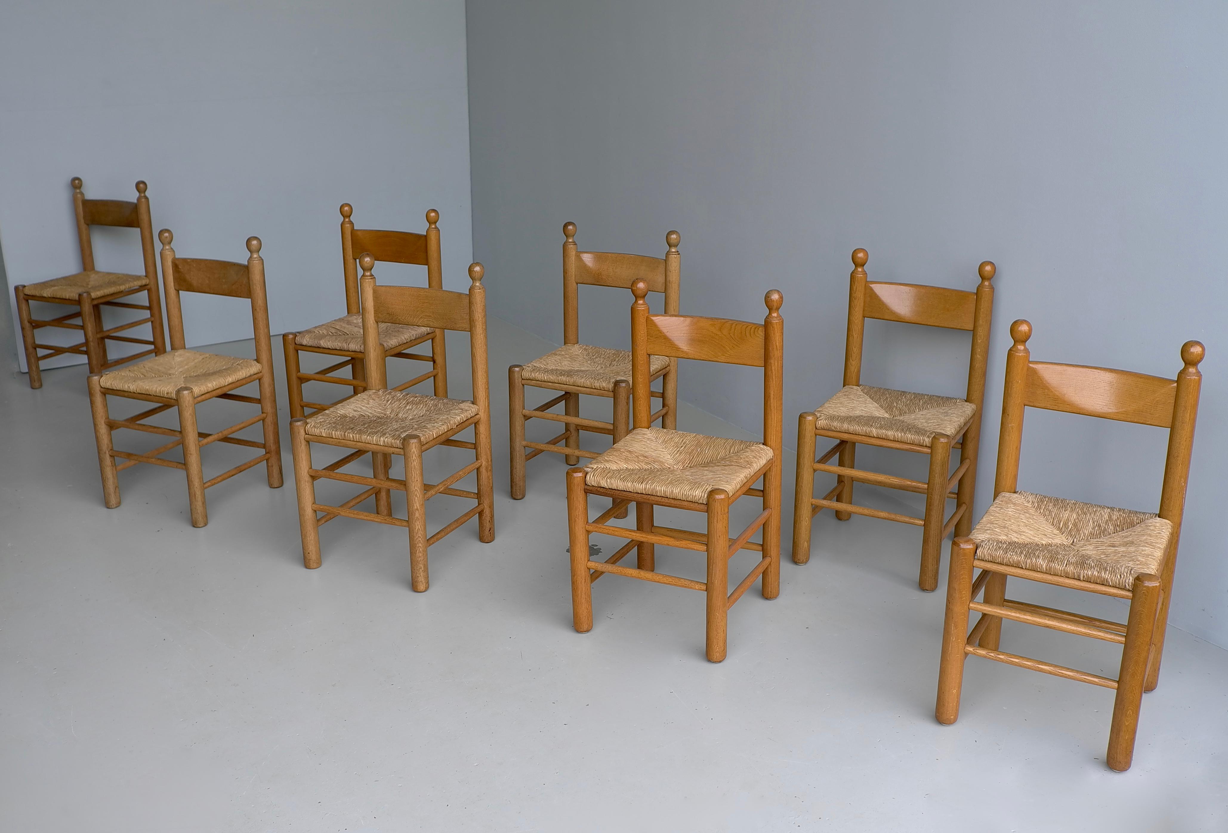 Oak and Rush Chairs in Style of Charles Dudouyt , France 1960's
Solid Oak chairs with rush seats, with lovely Patina to the wood. The listed price is per chair and we have 8 chairs in total available. 

