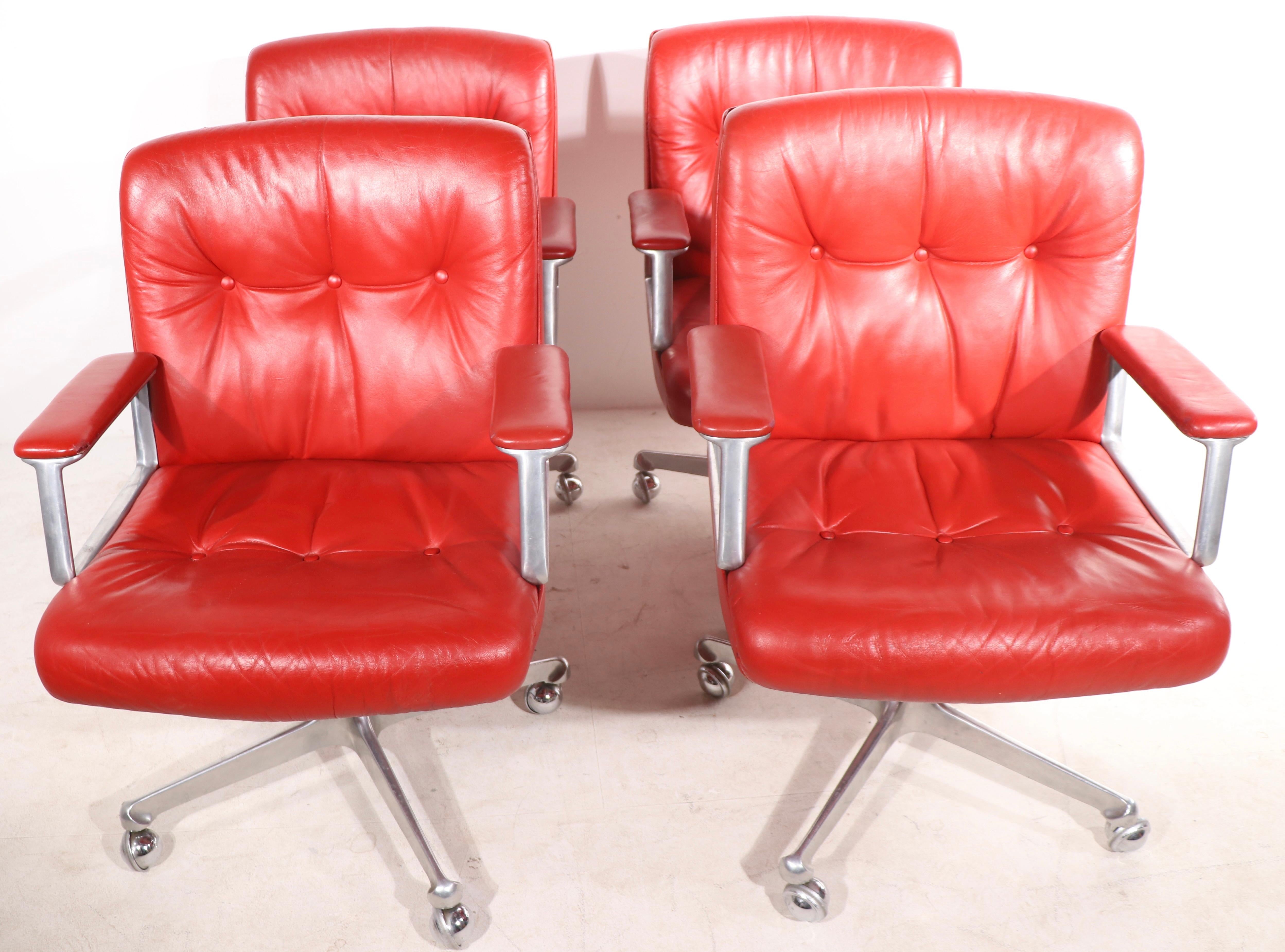 Sexy set of red leather Italian design swivel desk office chairs, by Osvaldo Borsani for Techno Collection Inc. The chairs are extraordinarily comfortable, they swivel and are adjustable in height ( Low Seat H 17.5 x High Seat H 19 - Low Back H 345