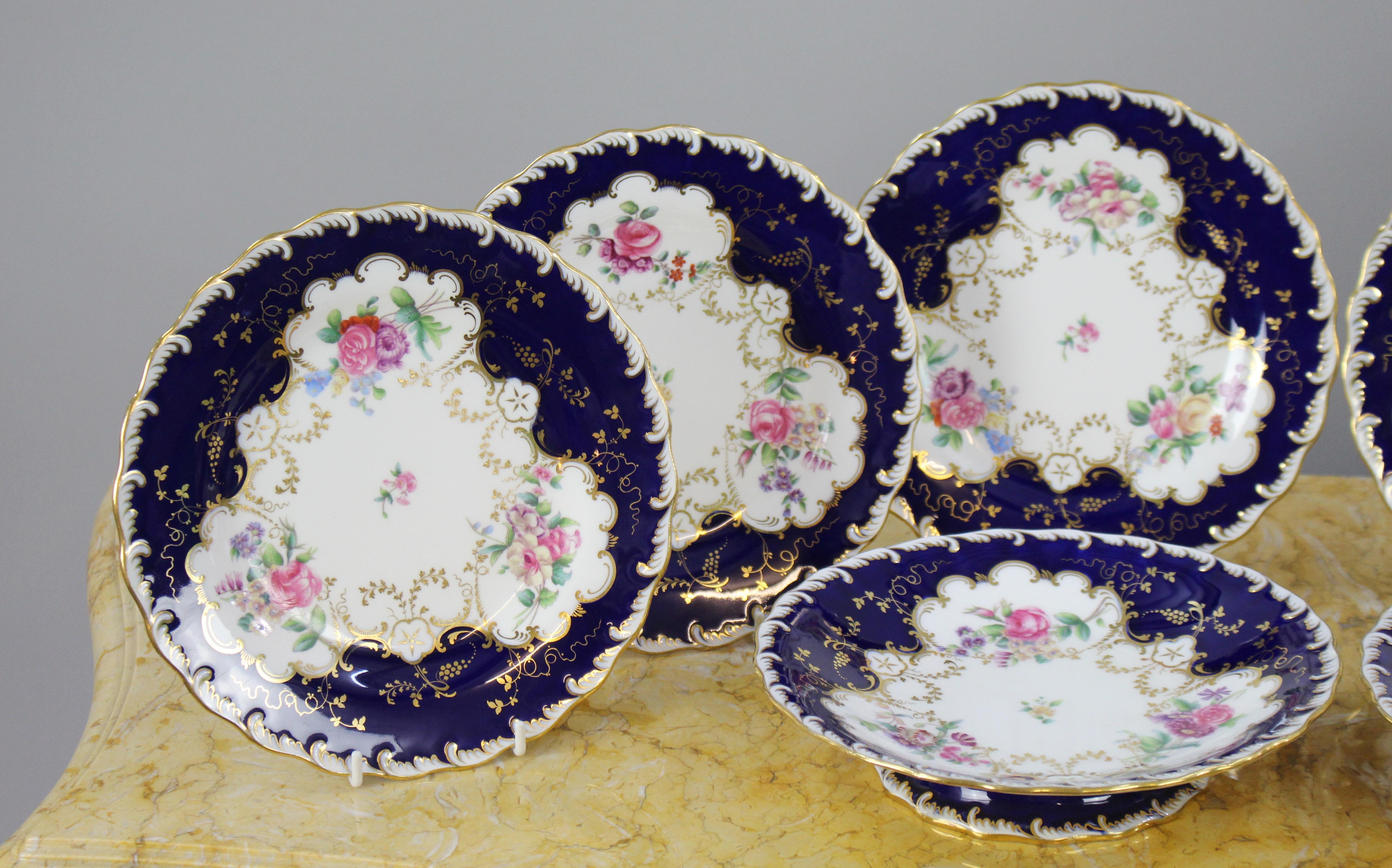 Manufacturer 
Minton

Decoration 
White & cobalt blue with floral decoration and gilding

Period 
c.1900

Pieces 
8 piece; 6 x 9 inche plates & 2 x 9 inch footed comports

Backstamp 
All pieces with puce factory stamp. First