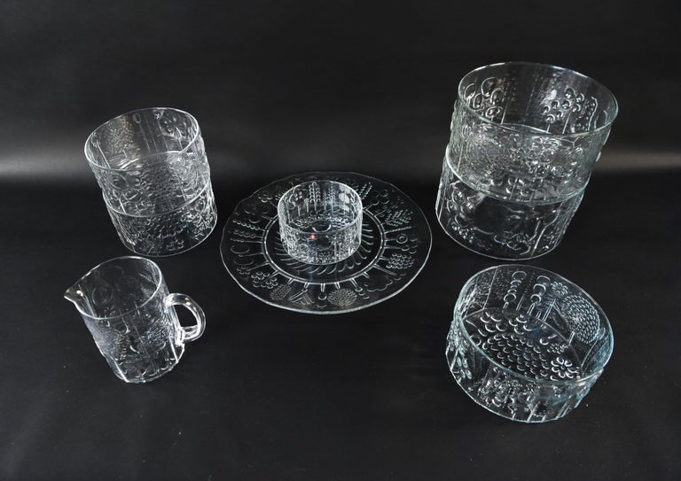 This is a well rounded grouping of midcentury Scandinavian glass. Including a platter, pitcher, and various bowls. Floral pattern designed by Oiva Toikka for Iittala.