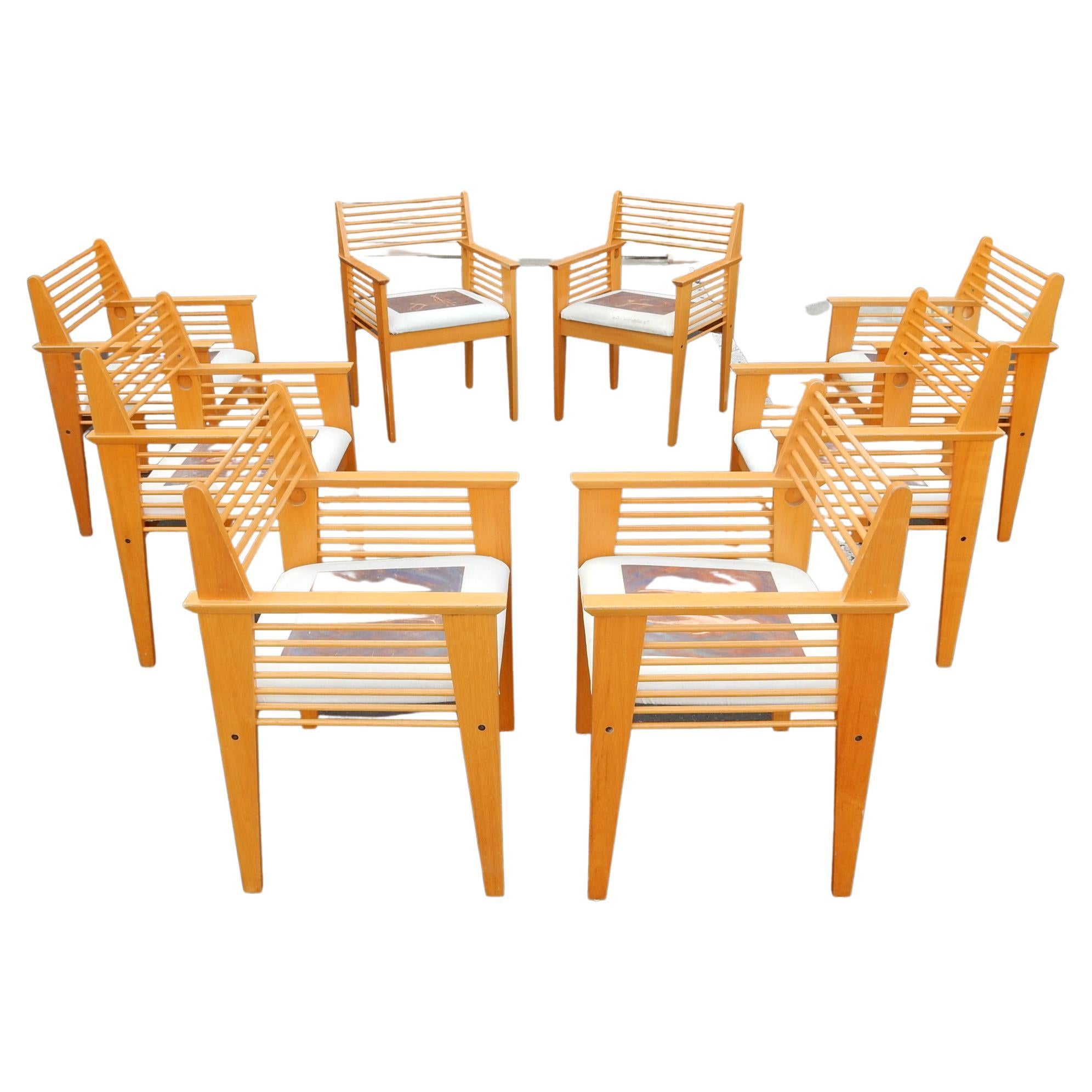 Set of 8 Post-Modern era spindle chairs in the Jean Prouve style.
Aesthetically pleasing. Light weight wood with golden Shellac finish.
Each seat cover is an original Giocometti style figural painting by Pennsylvania artist Jayson Clymer,
each