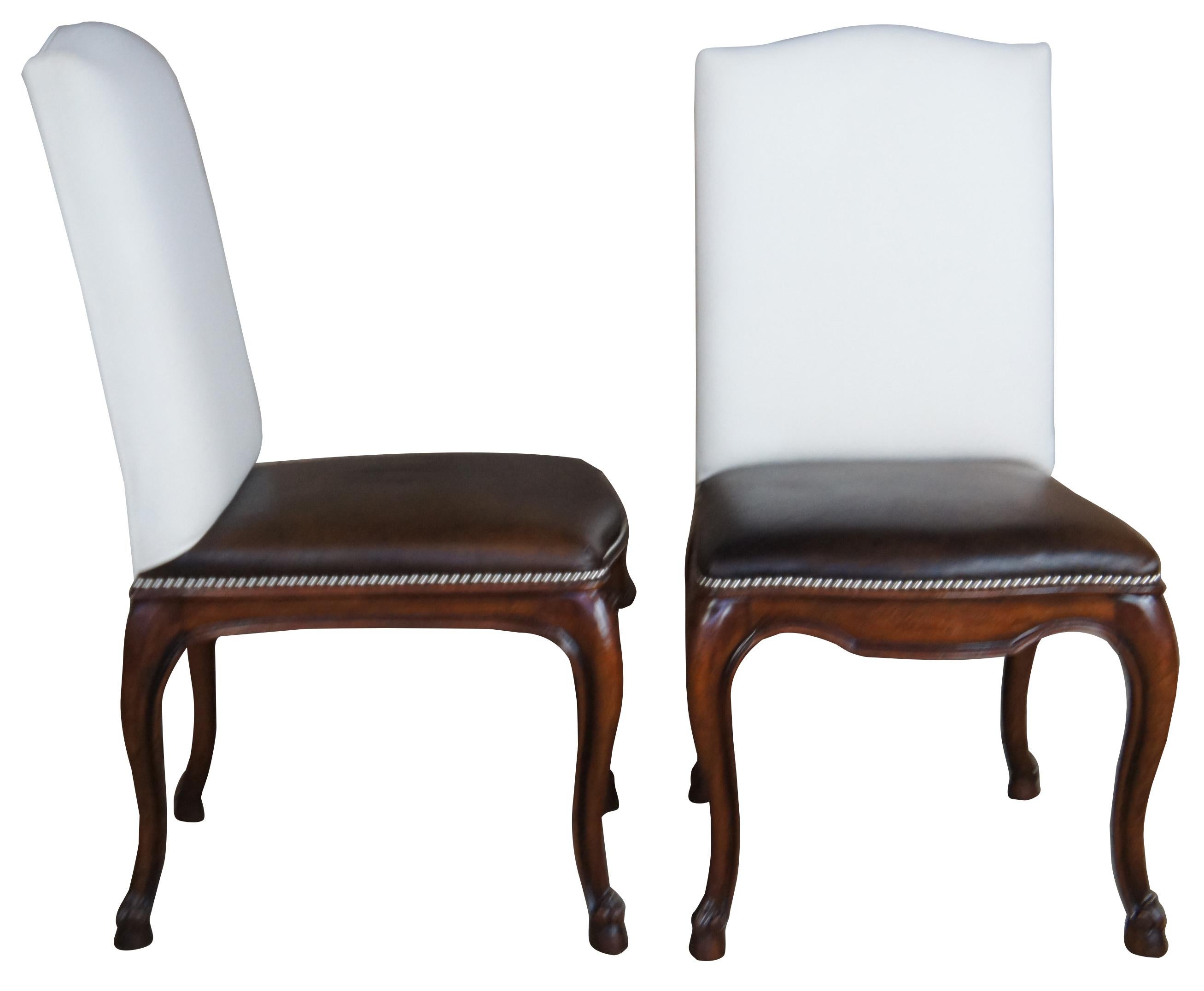 The Henredon Ralph Lauren Duke chair evokes traditional styling. Made from mahogany with leather seat and upholstered back. Features cabriole legs that lead to a hoof foot. Marked on underside. 1865-28-50.
  