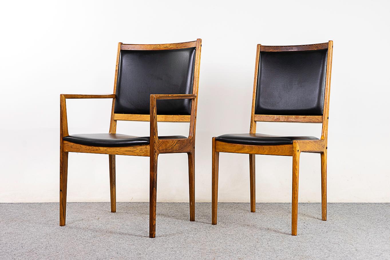 Rosewood dining chairs, circa 1960's. Beautiful angled joinery and clean modern lines, a very elegant presence. Original vinyl upholstery in nice condition.

Unrestored item with option to purchase in restored condition for an additional $1000 USD.