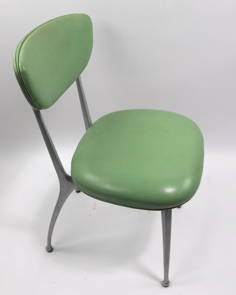 Set of 8 Shelby Williams Gazelle model Cafe Dining Chairs with aluminum legs and seafoam green vinyl upholstered seats and backrests. Very good original condition, vinyl shows very minor wear, one seat pad shows a repair to vinyl, as shown. Offered