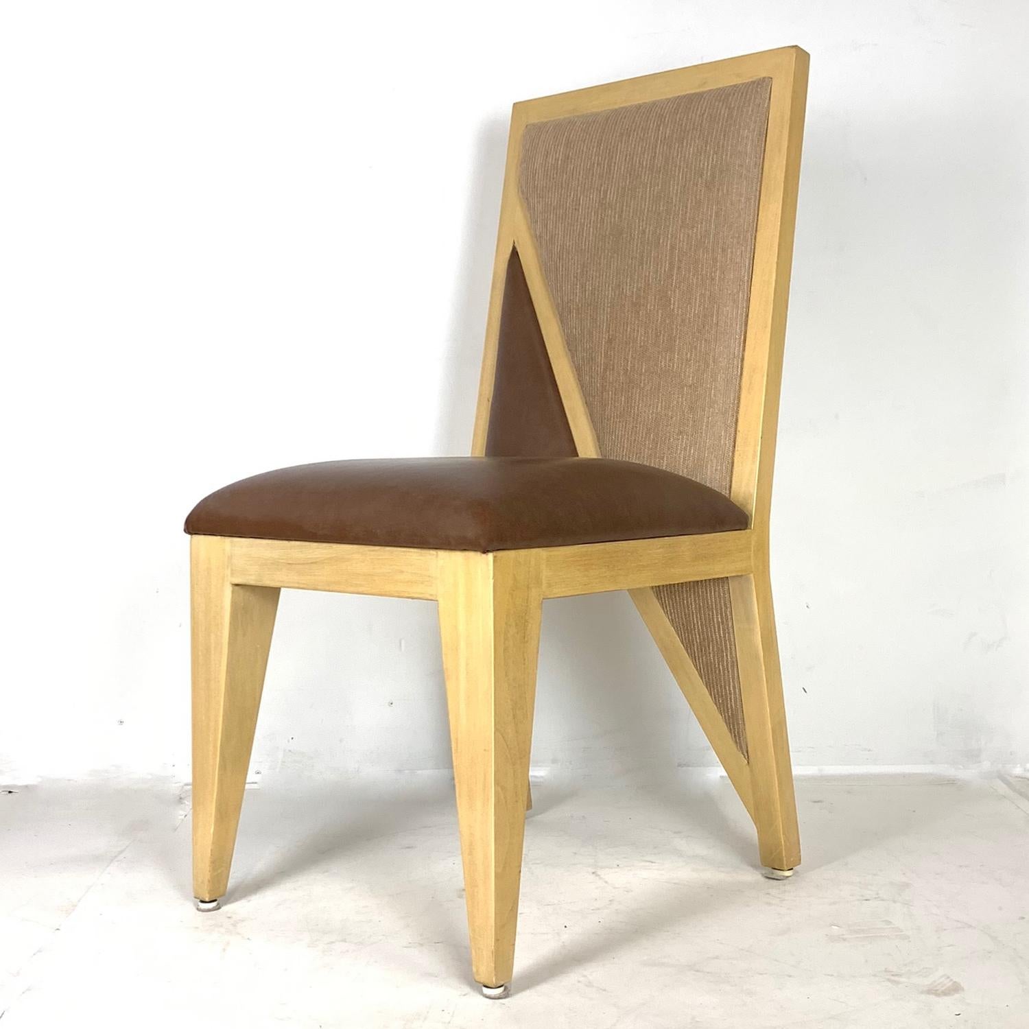 Fantastic set of very sturdy solid wood Postmodern chairs. 8 side chairs and 2 armchairs. These chairs are stunning. Seat upholstery is in Naugahyde for practical purposes.