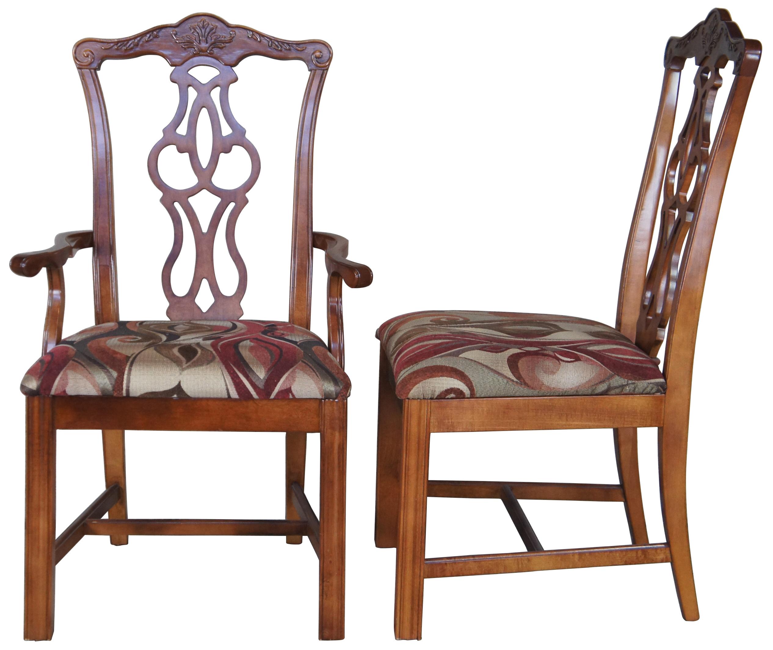 Set of eight Stanley Furniture dining chairs, circa 1980s. Made of cherry featuring traditional Chippendale styling, upholstered seat, and straight legs. Two arms, six sides.
 