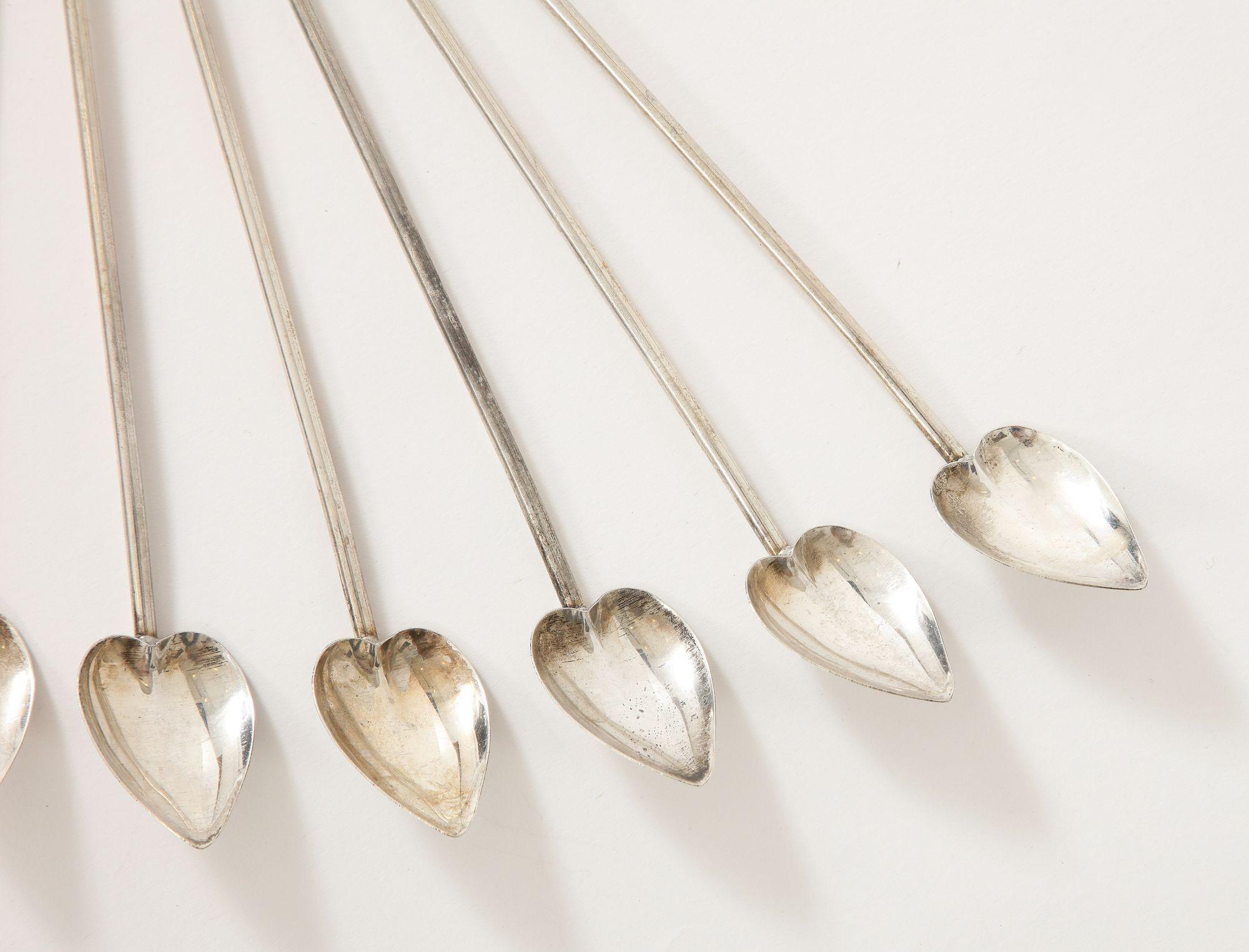 A set of 8 practical sterling silver heart shaped cocktail spoons/straws. These stirrers are a great complement to any cocktail party.
