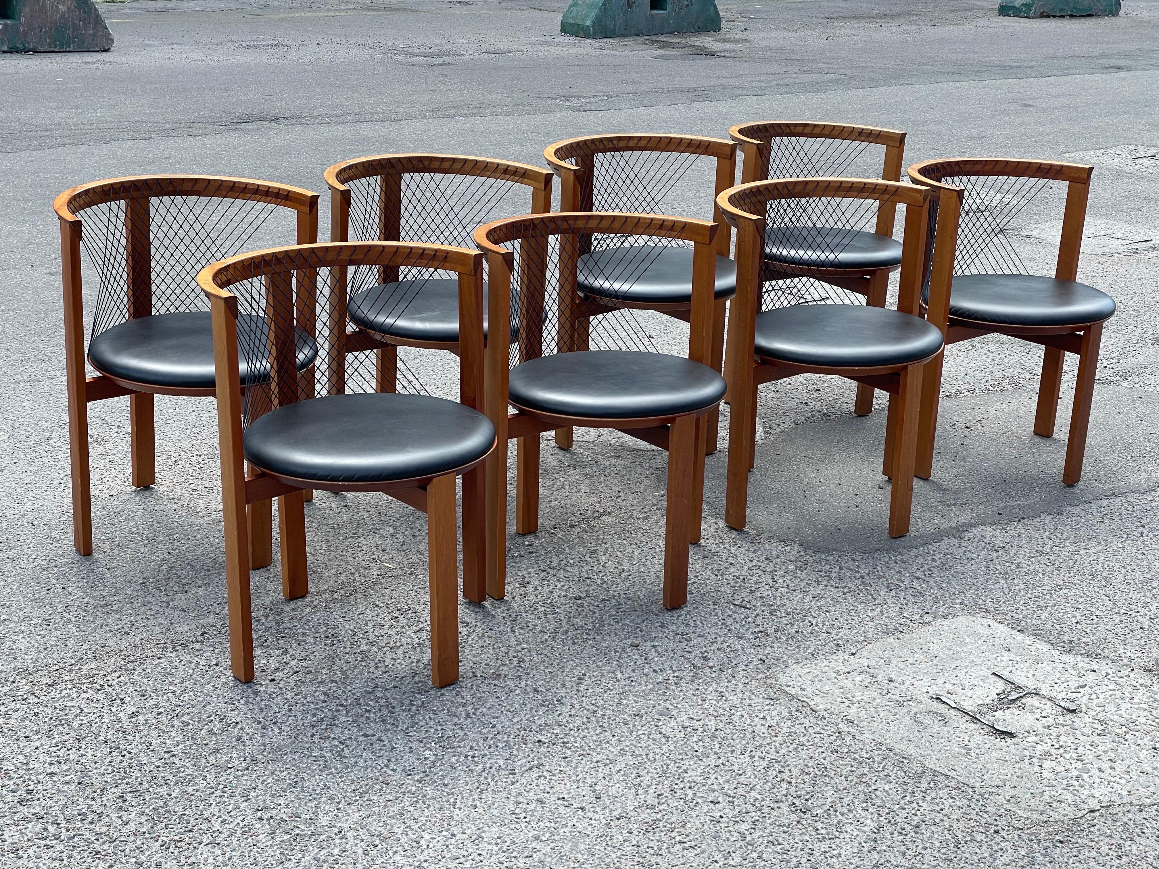 A rare gem for discerning collectors and design enthusiasts: a set of eight exquisite dining chairs designed by Niels Jørgen Haugesen for Tranekaer Denmark in the 1970s. These chairs are a testament to the timeless elegance and impeccable