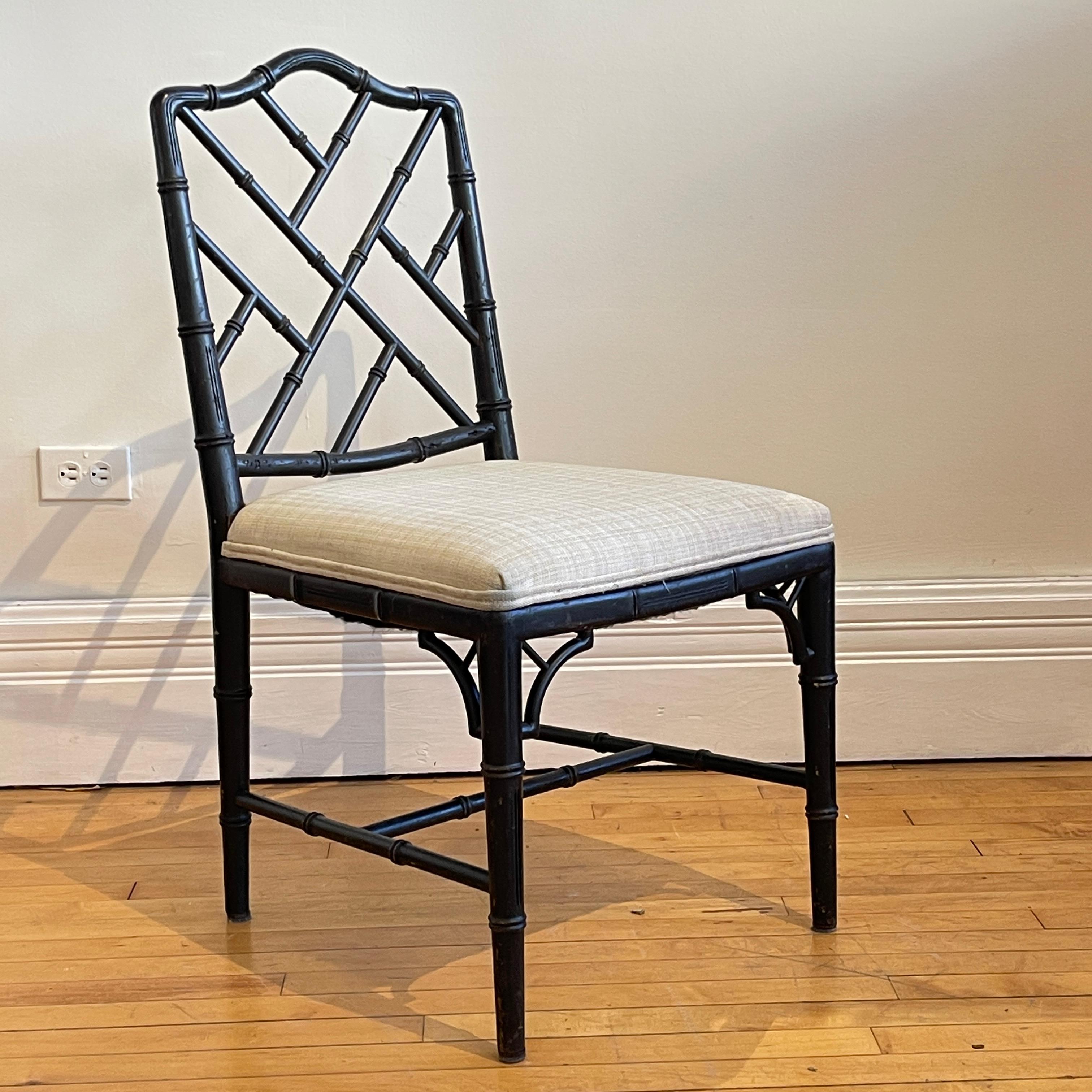 Set of 8 stunning faux bamboo wood chairs with cream colored heavy weave upholstery. Frames are carved hardwood with a lovely painted faux bois finish. This is a fabulously unique and usable set.

.