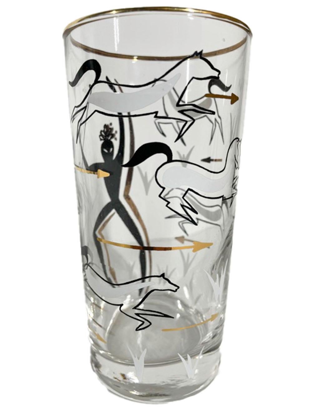 Eight Mid-Century Modern highball glasses decorated in black and white enamel with 22k gold, depicting a hunter with a bow among running horses and flying arrows.