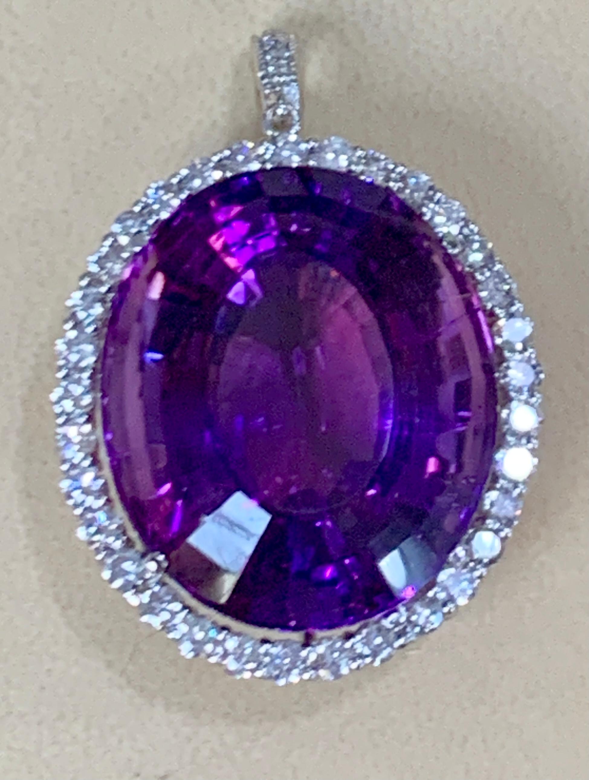   Approximately  80 Carat Amethyst & 3.5 Ct Diamond Pendant Necklace 14 Karat White Gold + Chain
This spectacular Pendant Necklace  consisting of a single large Oval Amethyst , approximately  80 Carat.  The  Amethyst   Has Circle of diamonds around