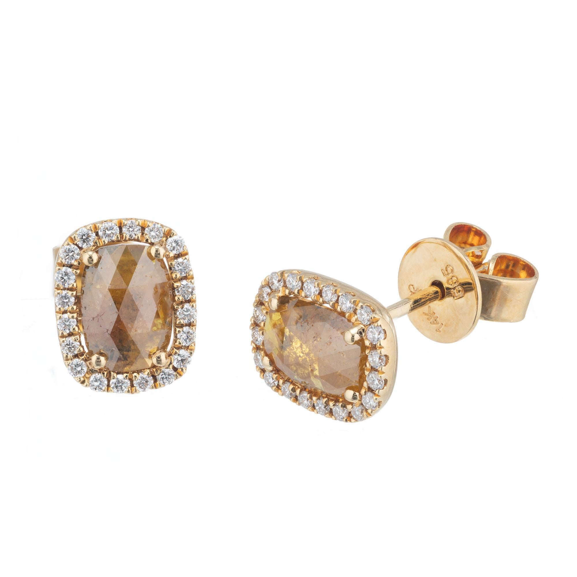Natural deep yellow brown cushion translucent diamonds set in 14k yellow gold settings with round halo accent diamonds.  

2 cushion faceted natural color fancy deep yellow brown diamonds, approx. total weight .80cts. Natural cold fancy deep yellow