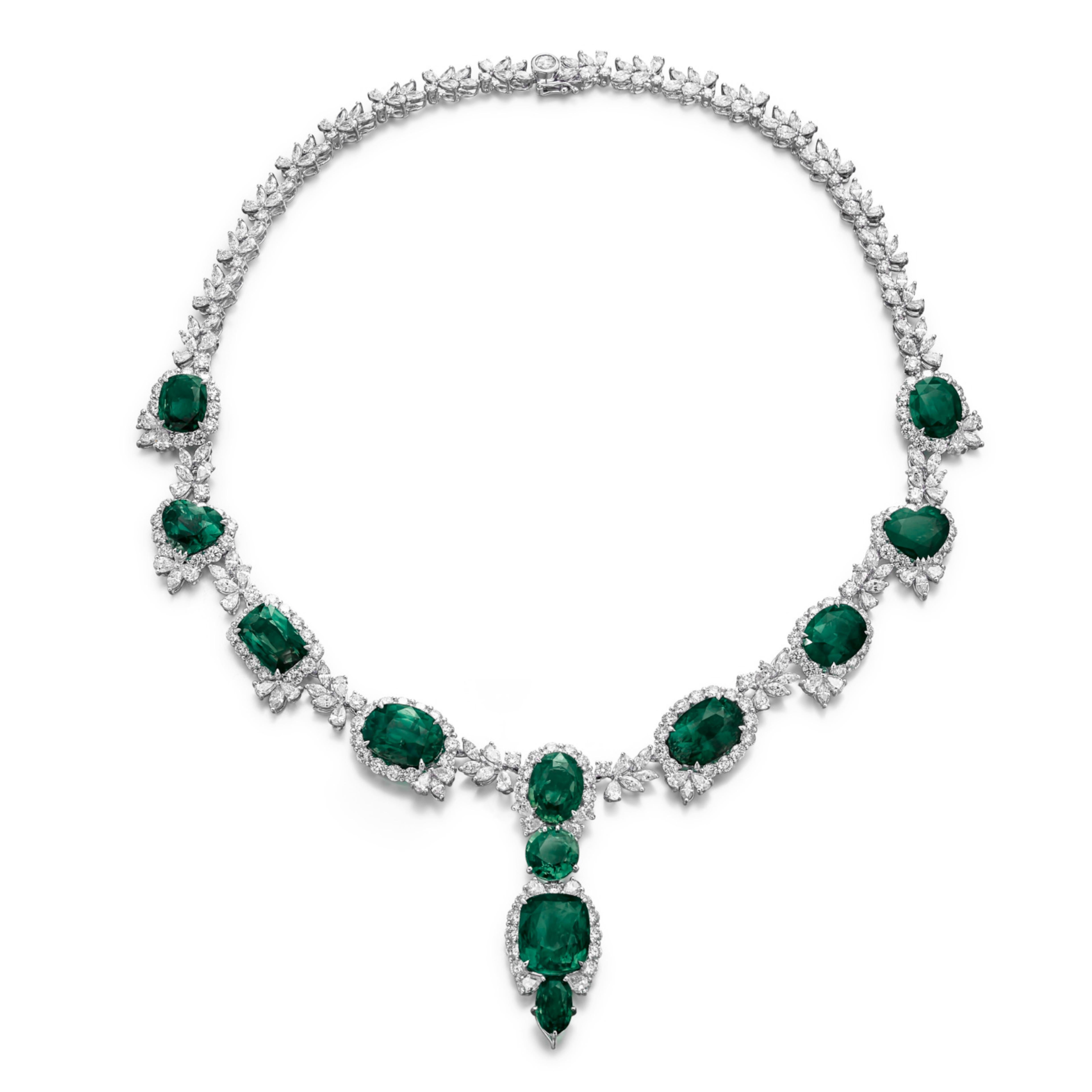 The necklace featuring twelve oval-, cushion- and heart-shaped natural emeralds weighing a total of 80 carats, decorated with pear-, marquise-shaped and round diamonds, the clasp set with a rose-cut diamond, pendant detachable, length 400mm; the