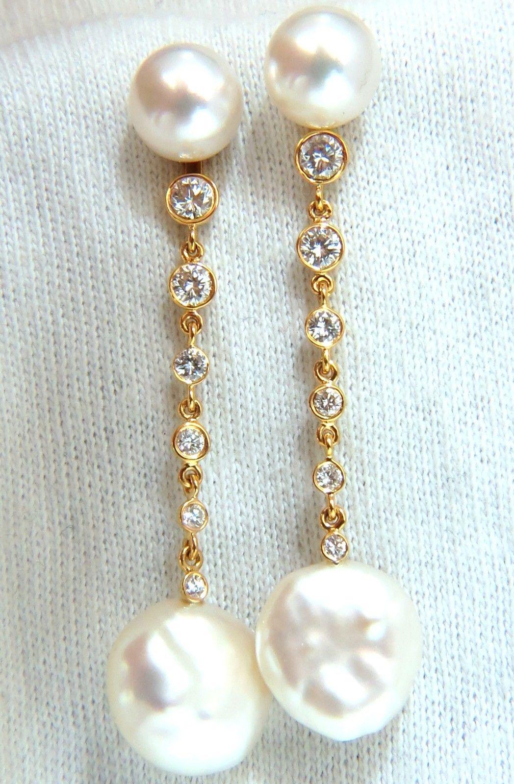 13mm round white pearl, south seas.



.80ct. round diamonds.



G-color & Vs-2 clarity.



Pearls Lower end:



13.5 X 7.5mm 





Overall earrings Measures:



2.13 inches long



14kt. yellow gold. 



8.5 Grams.



Beautiful Earrings.



$4,000