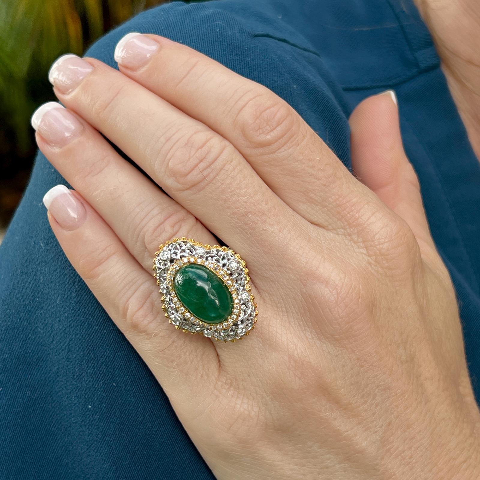 Stunning emerald diamond cocktail ring crafted in 18 karat yellow and white gold. The ring features an oval cabochon bright green emerald weighing approximately 8.00 carats. The natural emerald is set with surrounding prong and bezel set diamonds