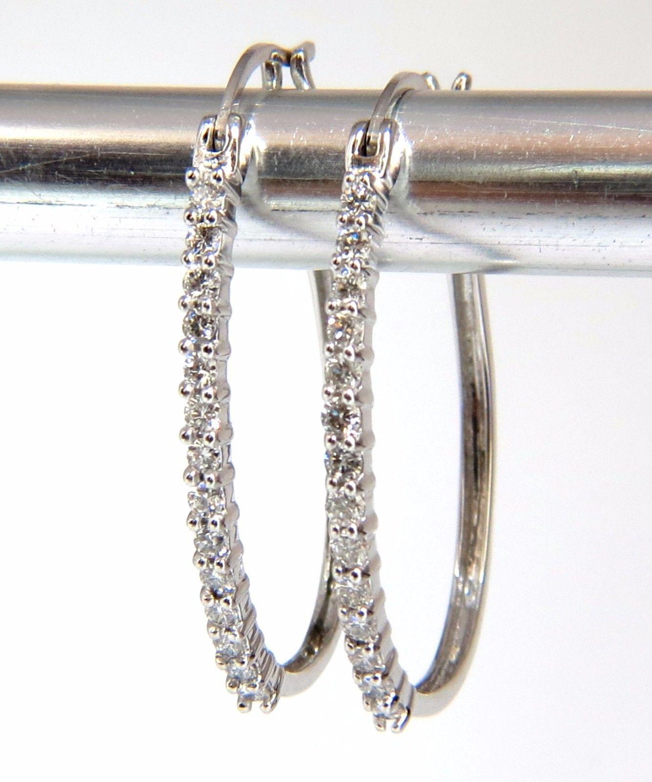 Elongated Hoop

.80ct. Natural diamonds  

Rounds, Full cut brilliants.

G- color Vs-2 Clarity. 

Secure lever backs

Excellent detail.

14kt. white gold

3.7 grams.

1.2 x .94 Inch.