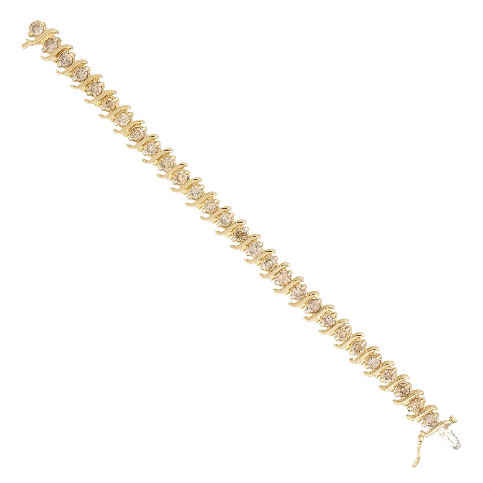 14k Yellow Gold 8.0ct Round Brilliant Cut Diamond S-Link Tennis Bracelet

Material: 14k Yellow Gold
Diamond Details: There are approximately 8.0 carats of round brilliant cut diamonds (28 stones)
Diamond Clarity: All diamonds are approximately SI-I1
