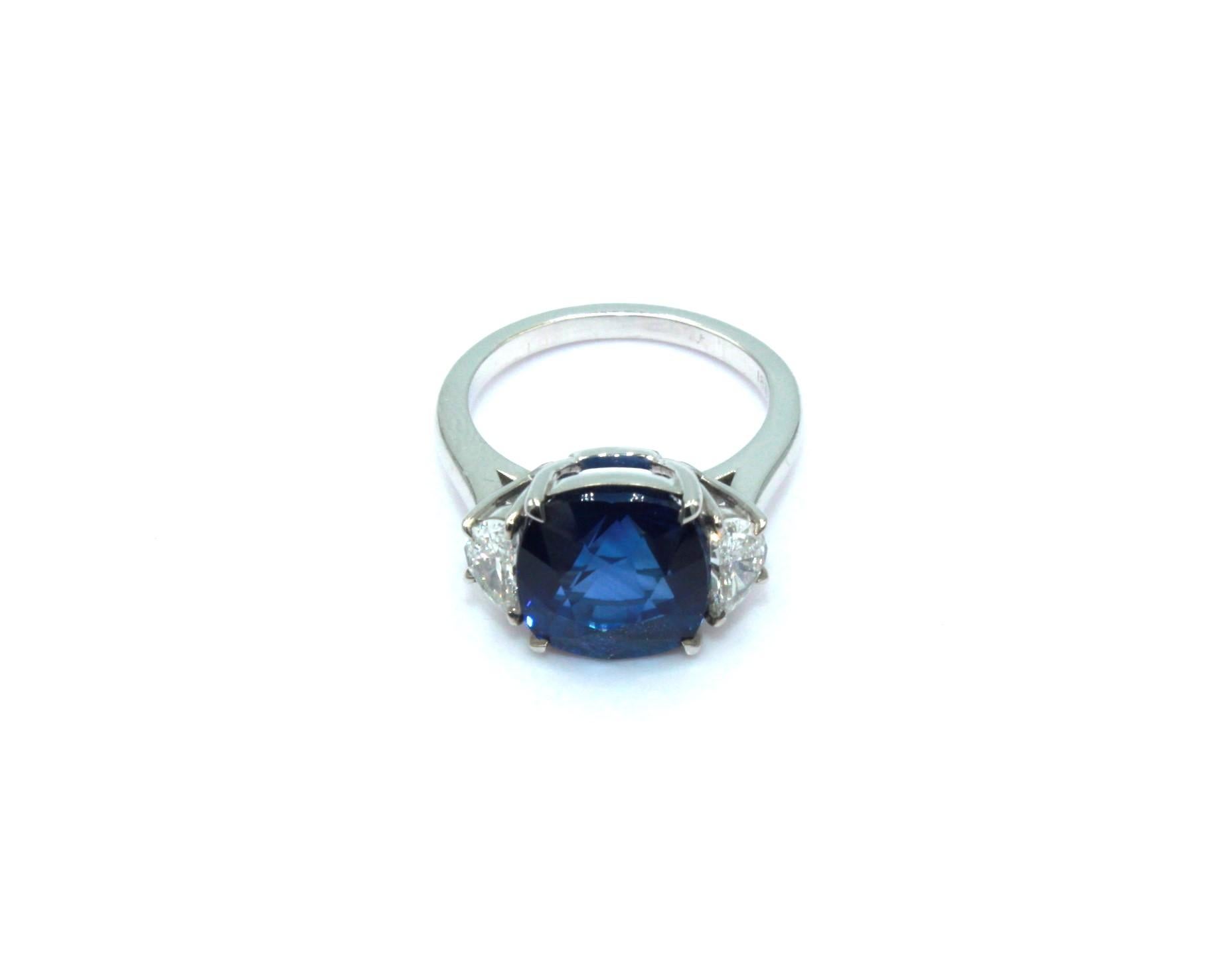 8.0 carats cushion Ceylon Sapphire, sided with 2 half-moon shaped diamonds, totaling a diamond weight of 0.64 carats. 

This stunning Sapphire Diamond Ring will highlight your elegance and uniqueness. 

Item Details:
- Type: Ring
- Metal: 18K Gold
-