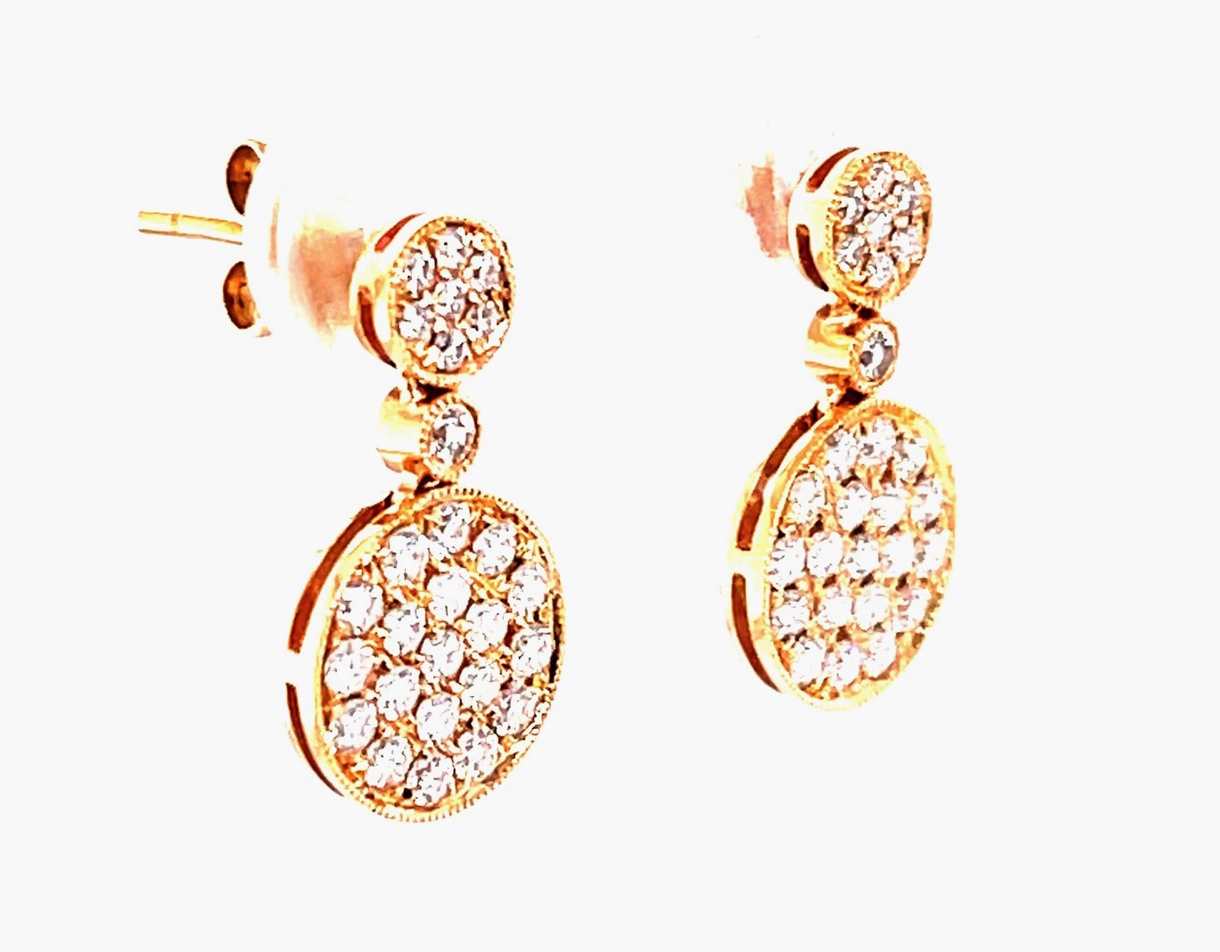 Modern, yet classic, these unique 18k rose gold and diamond earrings are extremely versatile!  Sparkling pave-set diamond discs sit on and just below the earlobe for a tailored and elegant look that can be worn day or night. Timeless style with an