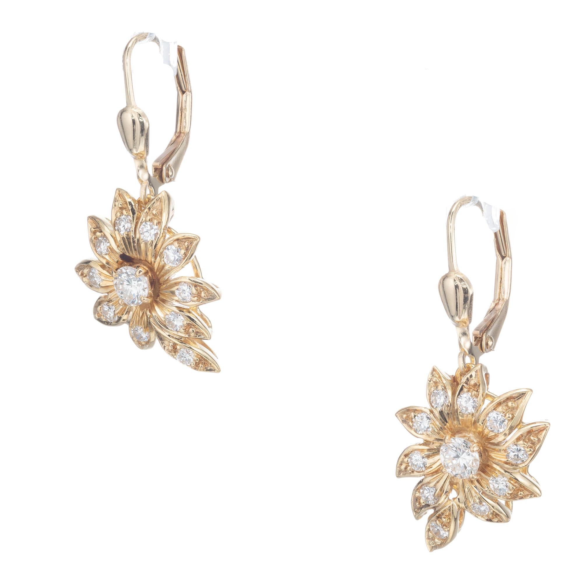 Diamond dangle flower earrings. 2 round center diamonds with 20 round accent diamonds in a flower design.

2 round diamonds, approx total weight: .30cts I-J VS-SI
20 round diamonds, approx total weight: .50cts G-H SI
Length: 1.23 inches or