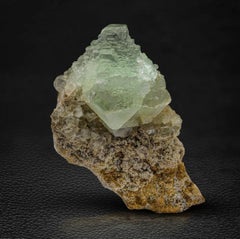 Cristal de fluorita verde multigradual de 80 gramos posado en una matriz procedente de Pakistán