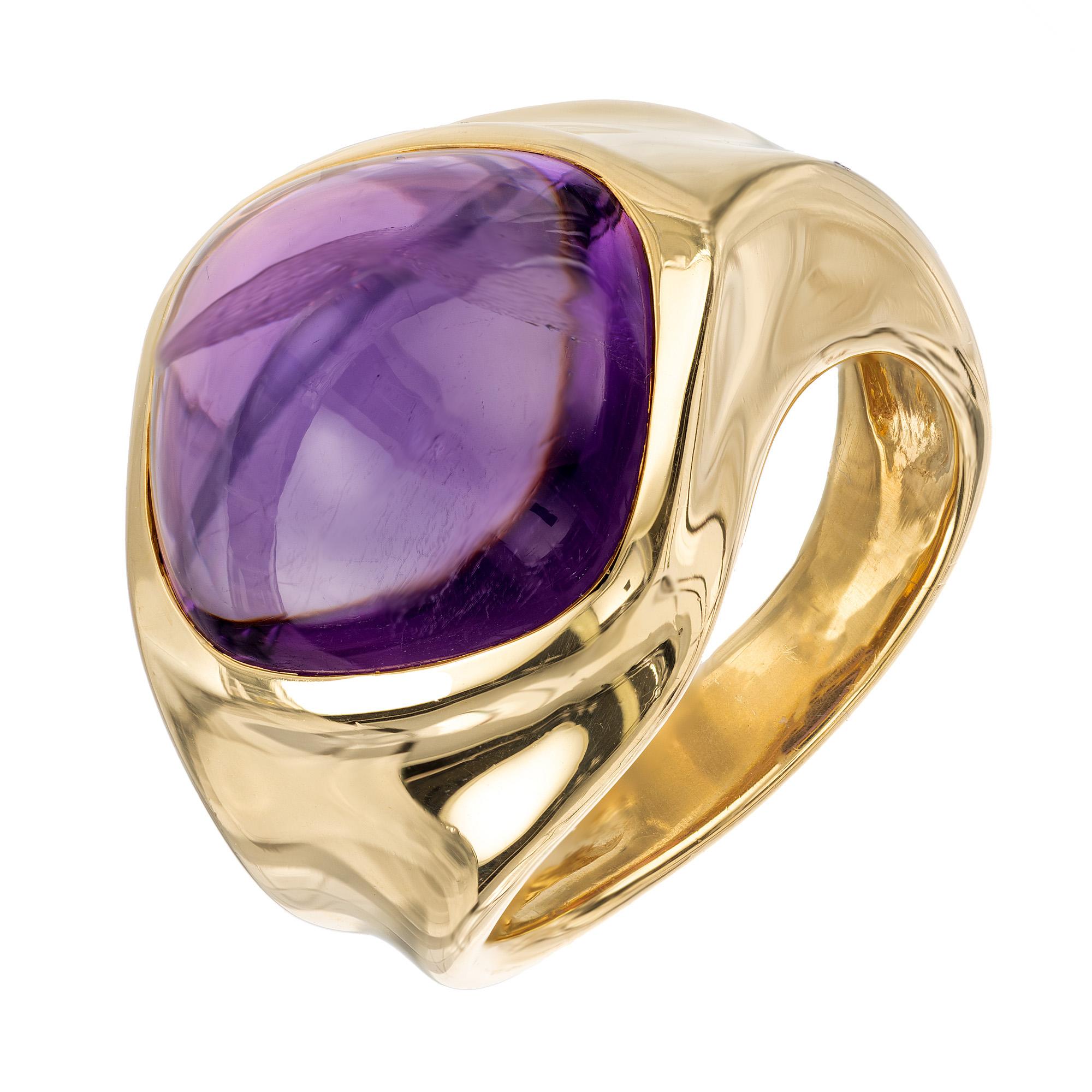 A wonderful vintage 1980's, 18k yellow gold, 8.00 carat cabochon amethyst bezel ring. The ring features an intricate twist design on the shank that adds a modern aspect to the classic beauty of the amethyst gemstone. The rich purple hue of the