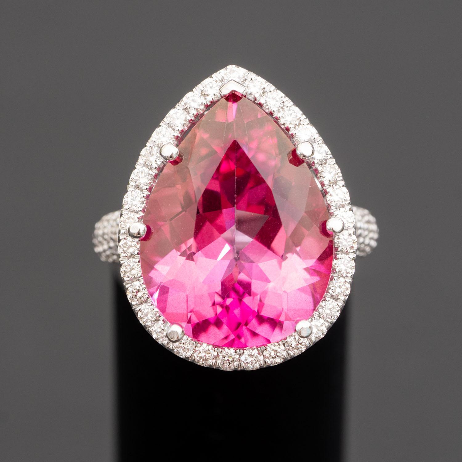 Capture the senses with color and dazzle them with brilliance - a full 18 carats’ worth. At the heart of this singular cocktail ring design, a pear-shaped heart of cerise natural topaz shines, ringed by brilliant-cut natural diamonds on the edges
