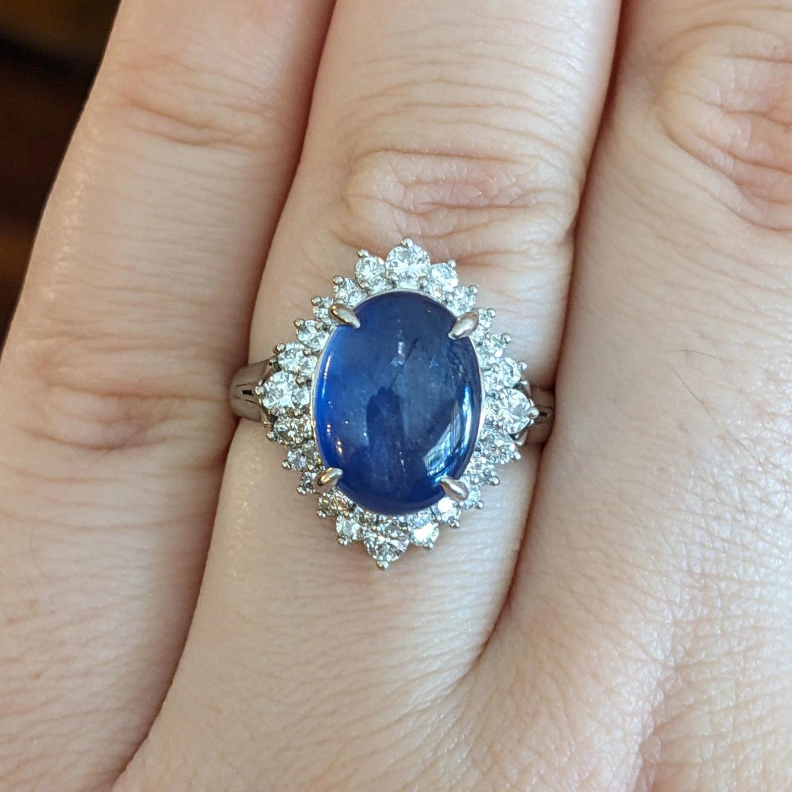 12.95 carats Oval Star Sapphire & Diamond Ring in Platinum

Star Sapphire and Diamond Ring features an Oval-shaped Violetish Blue Star Sapphire weighing 12.95 carats surrounded by Baguettes and Round Brilliant cut Diamonds, all set in a Platinum