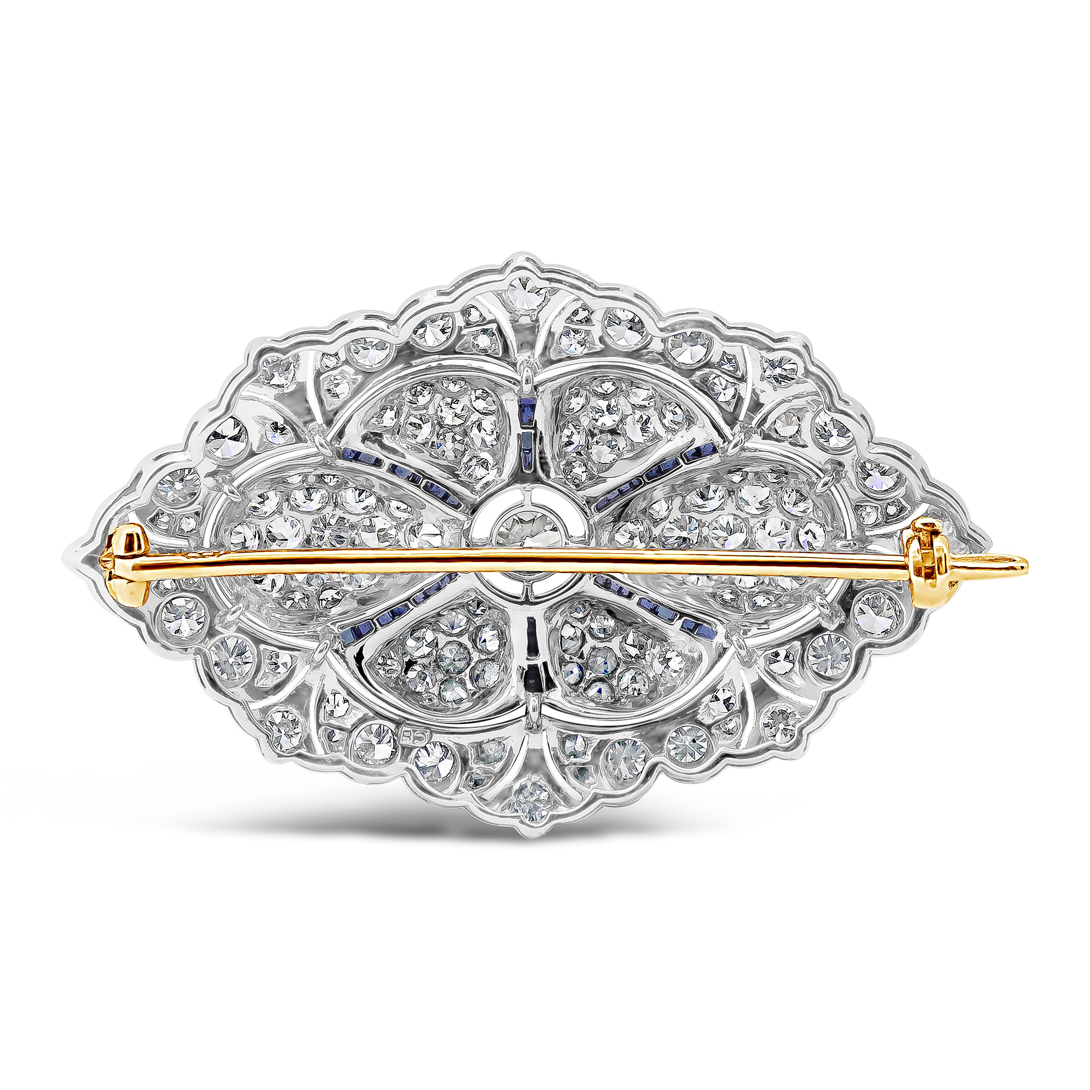 Showcasing an antique diamond encrusted brooch accented with square cut blue sapphires. Diamonds weigh 8.00 carats total while the blue sapphires weigh 0.40 carats total. Finely made in 18k white gold and yellow gold.